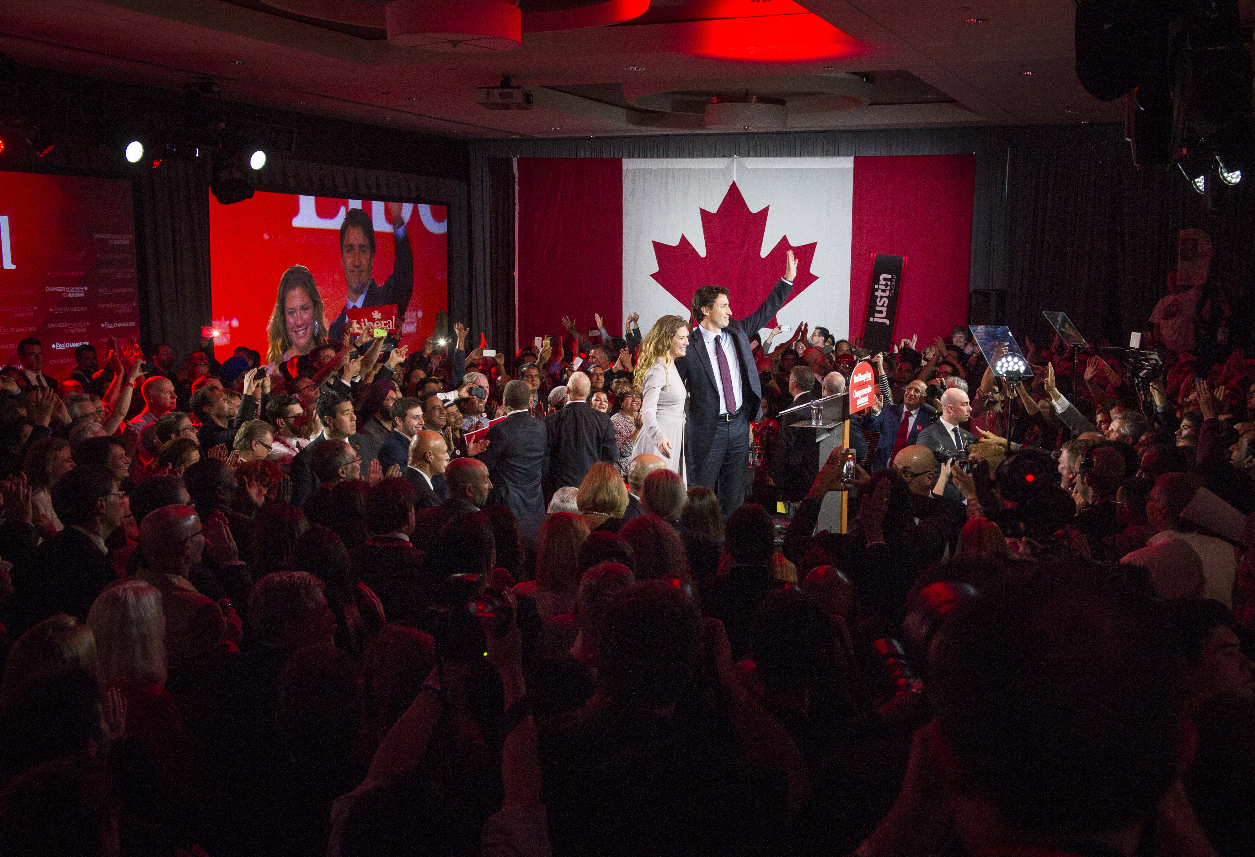 Justin Trudeau, Canada's prime minister-elect and leader of the Liberal Party of Canada, and his wife Sophie Gregoire-Trudeau wave to supporters on election night in Montreal, Quebec, Canada, on Oct. 20, 2015. (Kevin Van Paassen—Bloomberg/Getty Images)