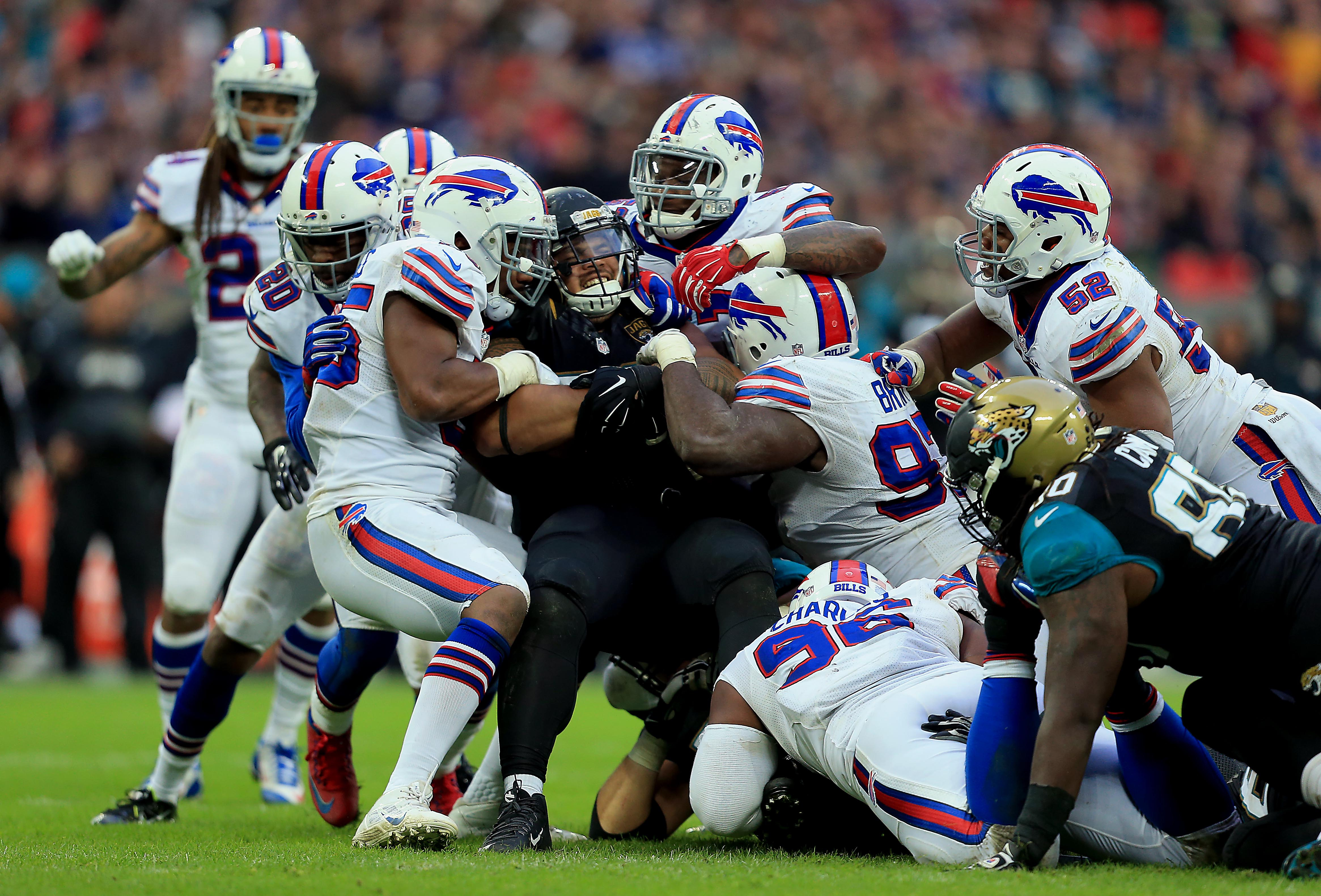 Jacksonville Jaguars' Tyson Alualu (#93) is tackled during an NFL football game against the Buffalo Bills on Oct. 25, 2015 at Wembley Stadium in London. (Stephen Pond—Getty Images)