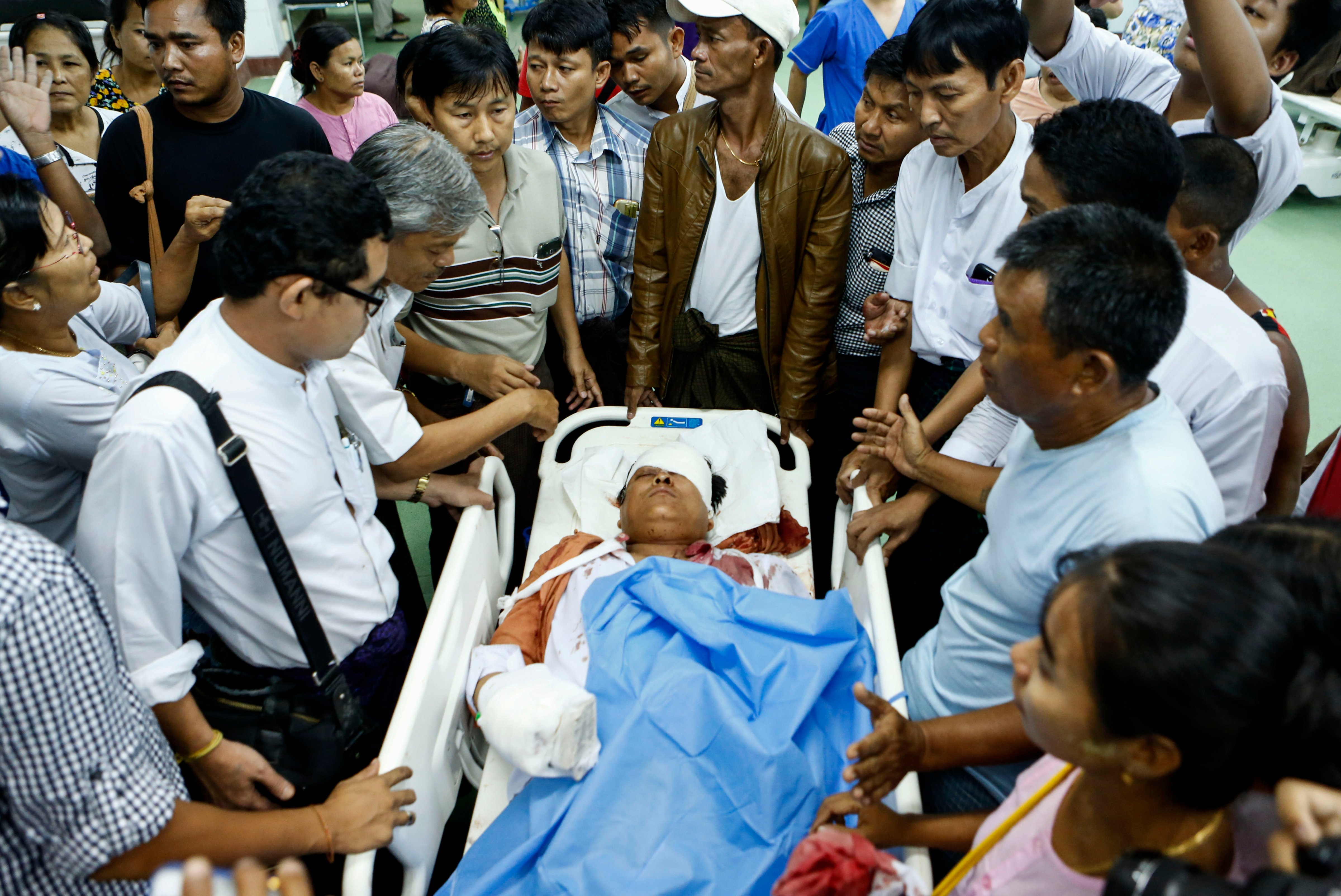 Injured NLD MP Naing Ngan Lynn lies on bed as he arrives at Yangon General Hospital in Rangoon on Oct. 29, 2015 (Lynn Bo Bo—EPA)