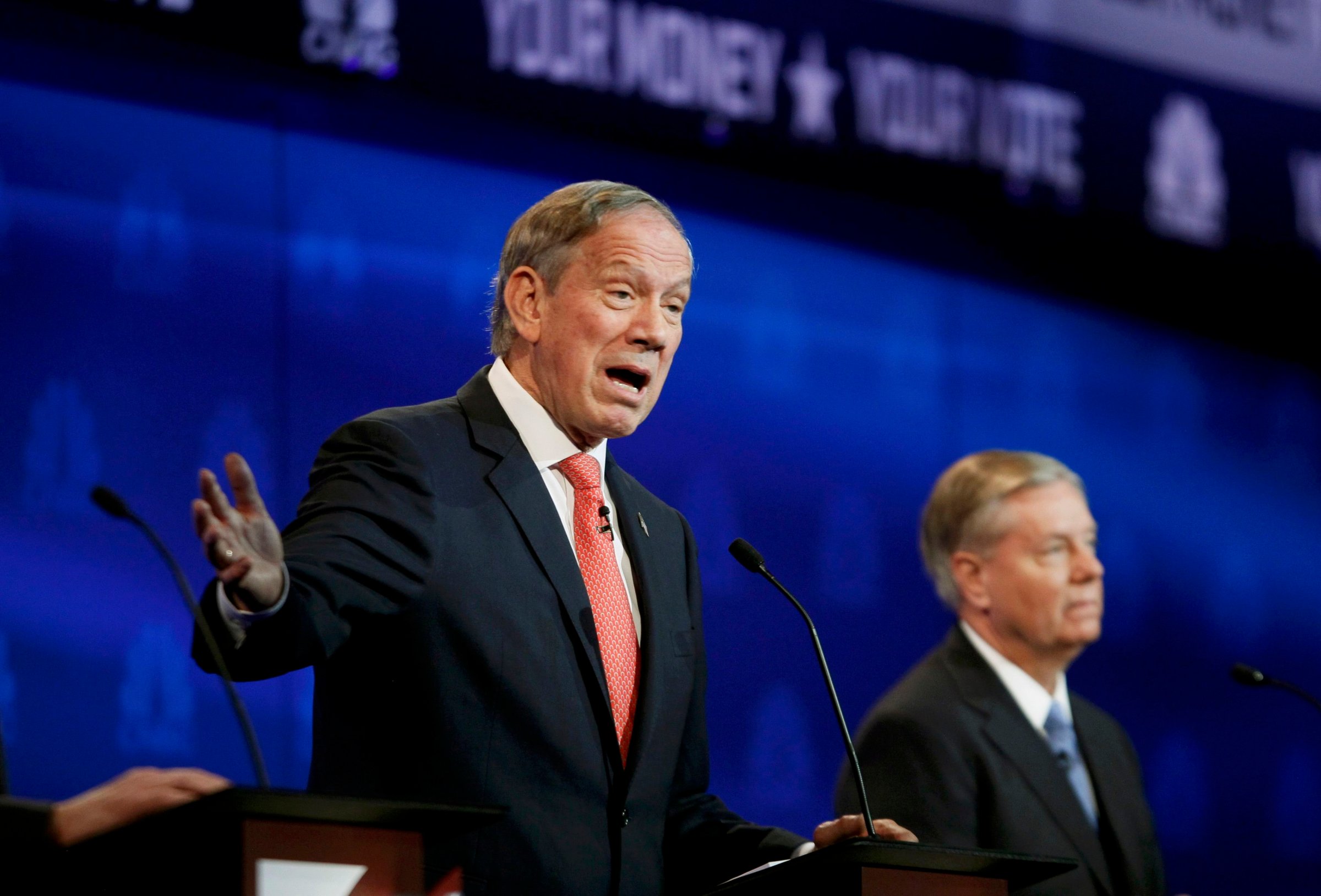 Republican U.S. presidential candidate Pataki speaks as Graham listens at a forum for lower polling candidates held by CNBC before the main debate in Boulder
