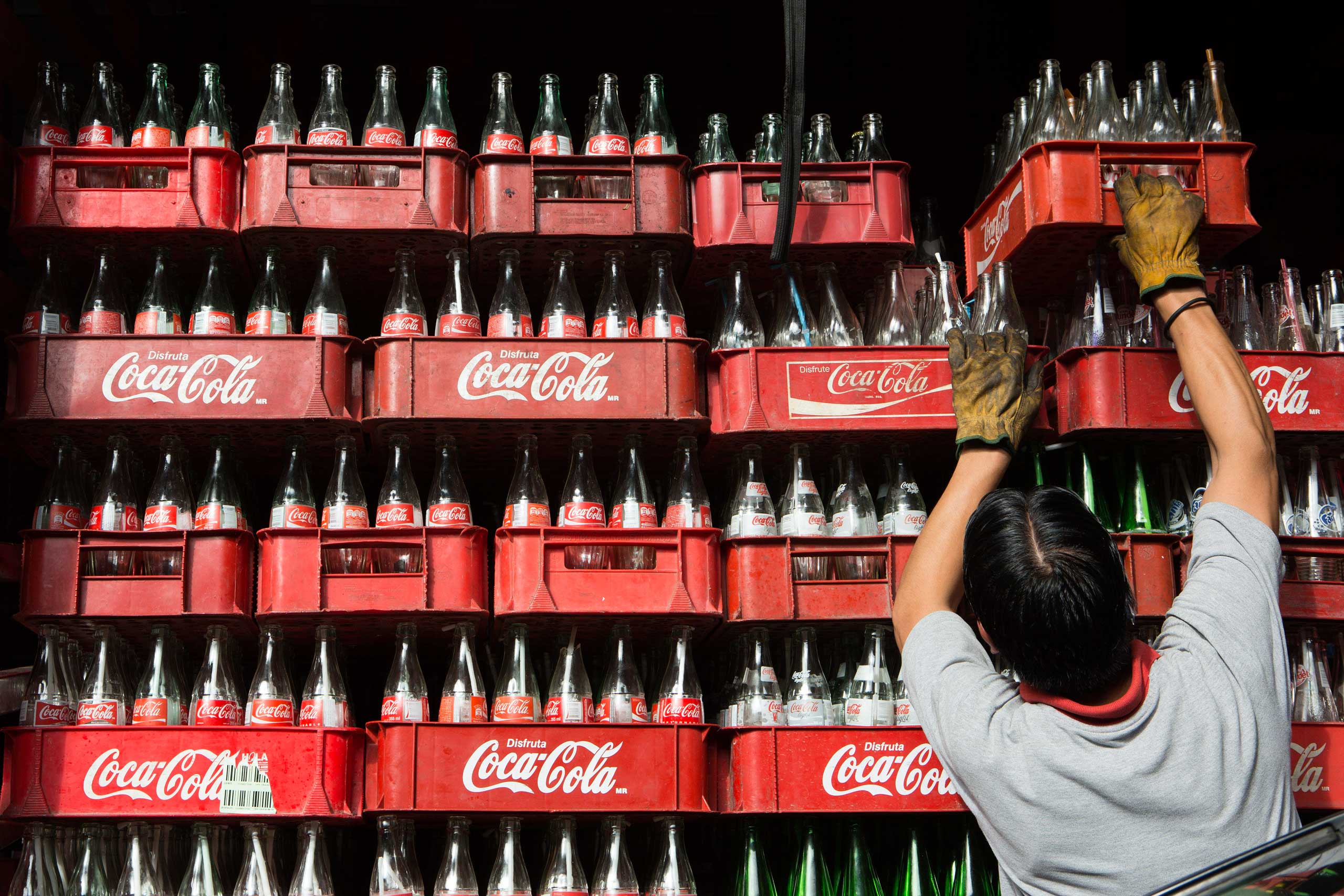 A worker loads a delivery truck with empty Coca-Cola bottles in Mexico City in 2013. (Susana Gonzalez—Bloomberg/Getty Images)