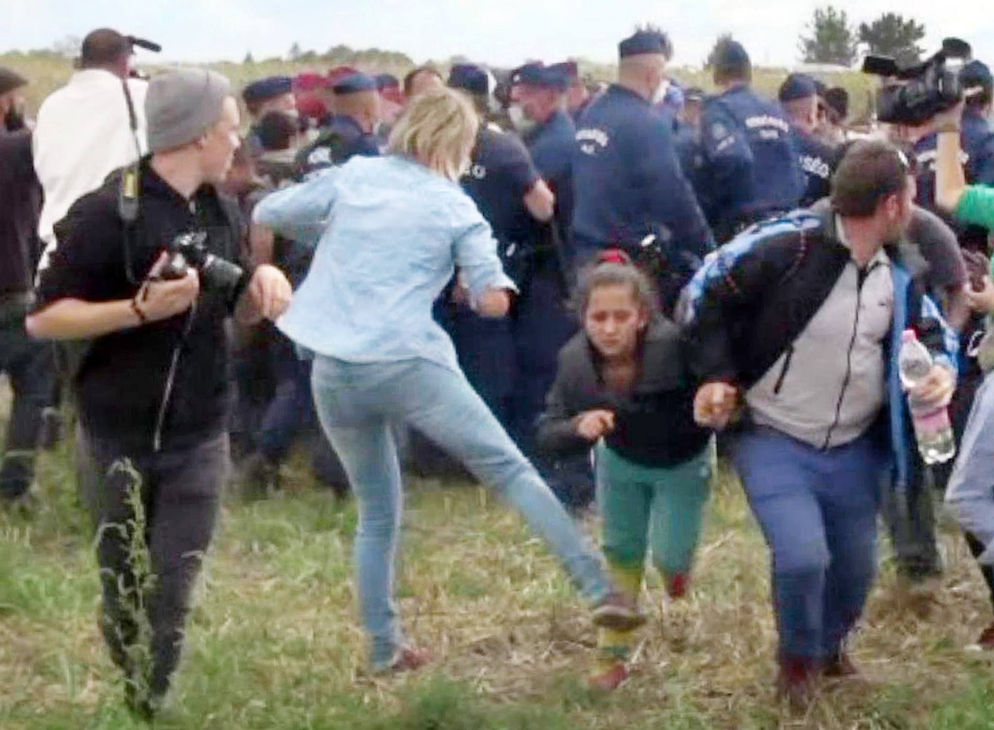 This video grab made on Sept. 9, 2015 shows Petra Laszlo kicking a child as she run with other migrants from a police line during disturbances in Roszke, southern Hungary. (AFP/Getty Images)