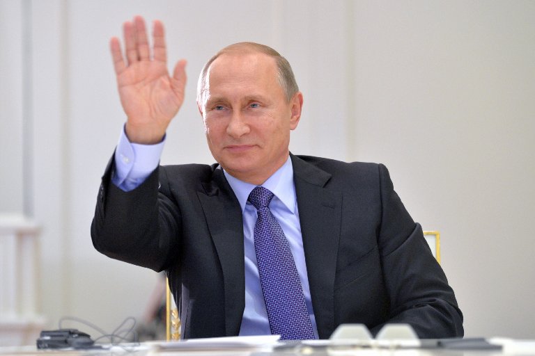 Russian President Vladimir Putin waves during a videoconference on Oct . 21, 2015, in Moscow. (Alexei Druzhinin—ITAR-TASS/Corbis)