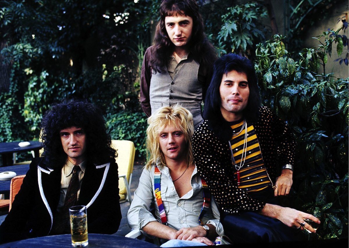 (L-R) Brian May, John Deacon (standing), Roger Taylor and Freddie Mercury of British rock group Queen at Les Ambassadeurs where they were presented with silver, gold and platinum discs for sales in excess of one million of their hit single 'Bohemian Rhapsody', which was No 1 for 9 weeks, on Sept. 8, 1976 in London (Anwar Hussein—Getty Images)