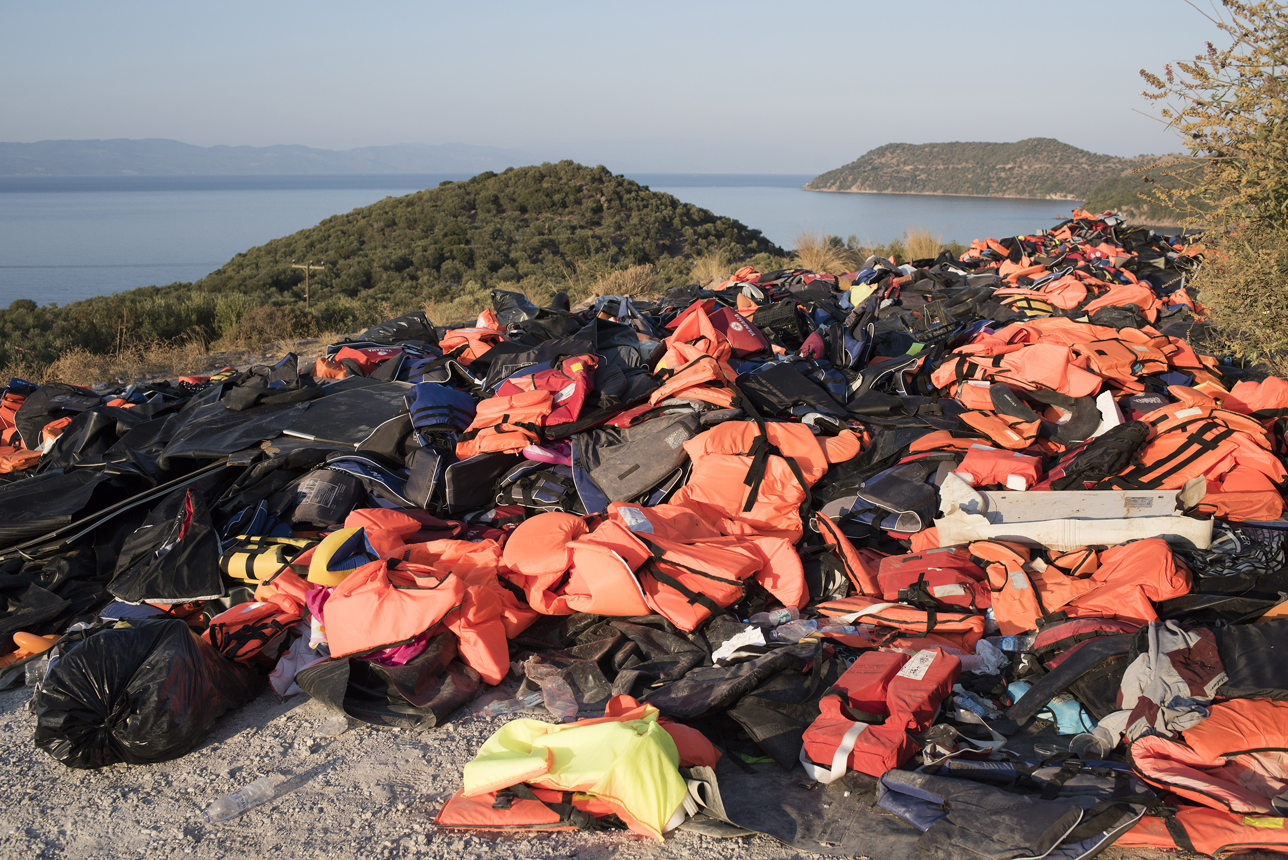 A beach  on the Greek island of Lesbos is festooned with orange life jackets and deflated rafts abandoned by migrants who are coming ashore near the village of Skala Sikamineas after navigating the 6-mile crossing from Turkey on  inflatable rafts.  Between 2,000 and 3,500 migrants now reach the island daily, riding on about 100 inflatable rafts. Sept., 2015.From <a href="http://time.com/4047547/europe-refugees-migrants-yuri-kozyrev/">"Witness the Resilience of Thousands of Refugees on Their Way to Europe"</a> (Yuri Kozyrev—NOOR for TIME)