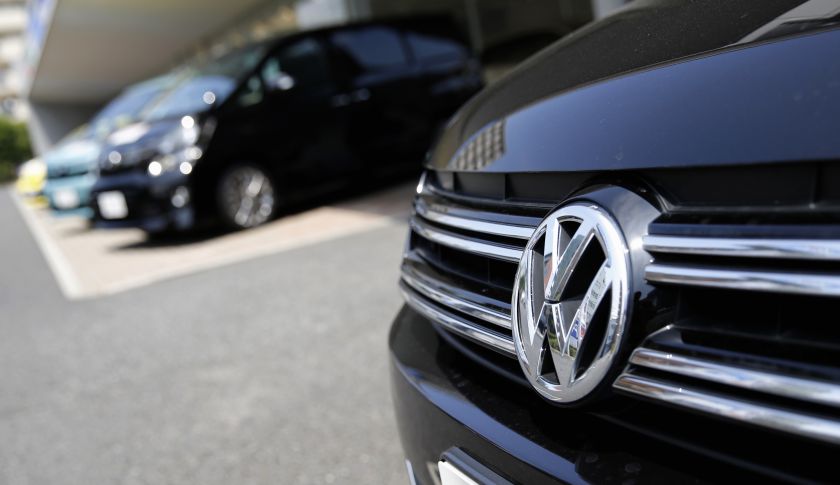 A Volkswagen car is seen in front of Toyota Motor Corp cars at their dealership in Tokyo