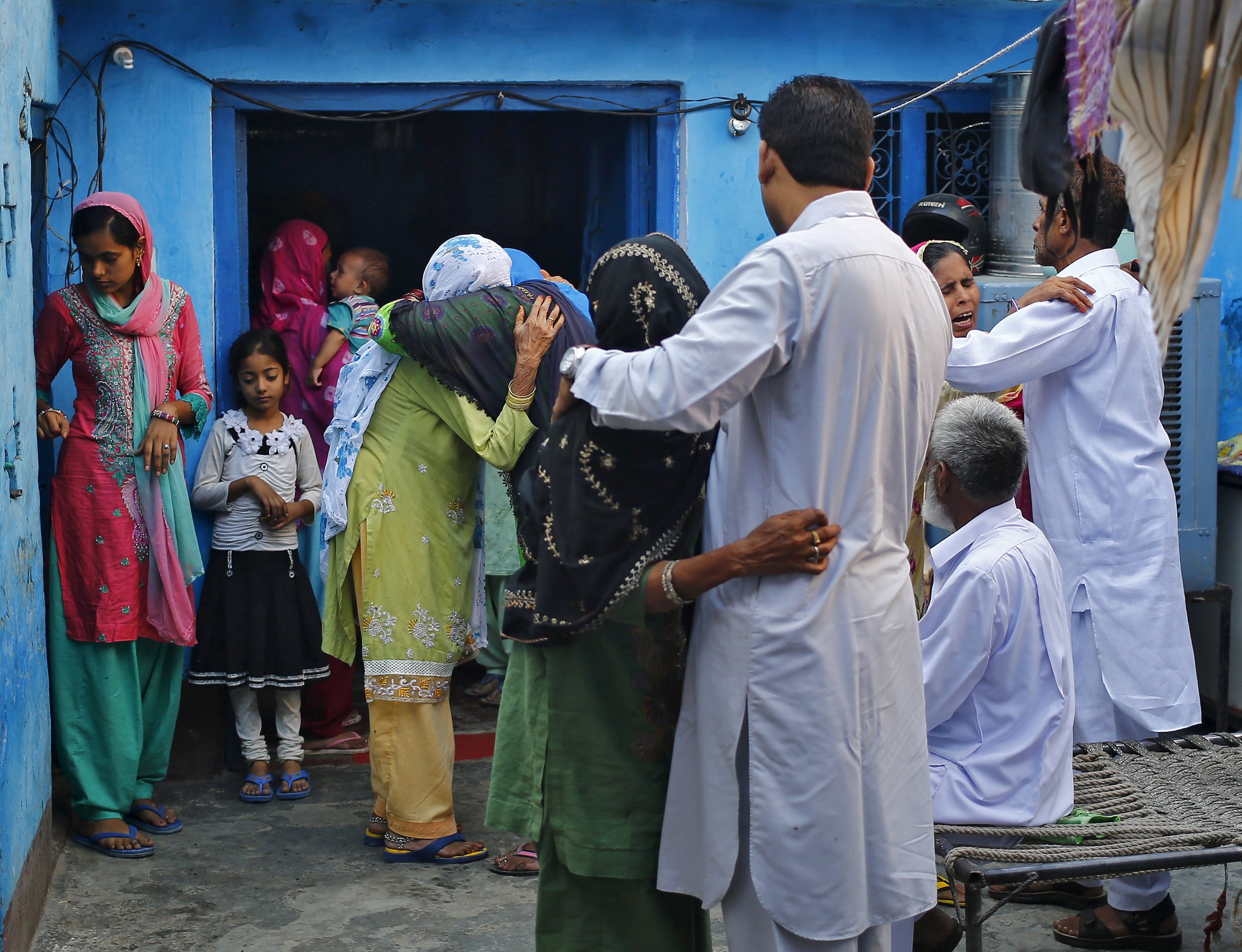 Relatives and family members of Saifi, who was killed by a mob, mourn his death at Bisara village in Uttar Pradesh