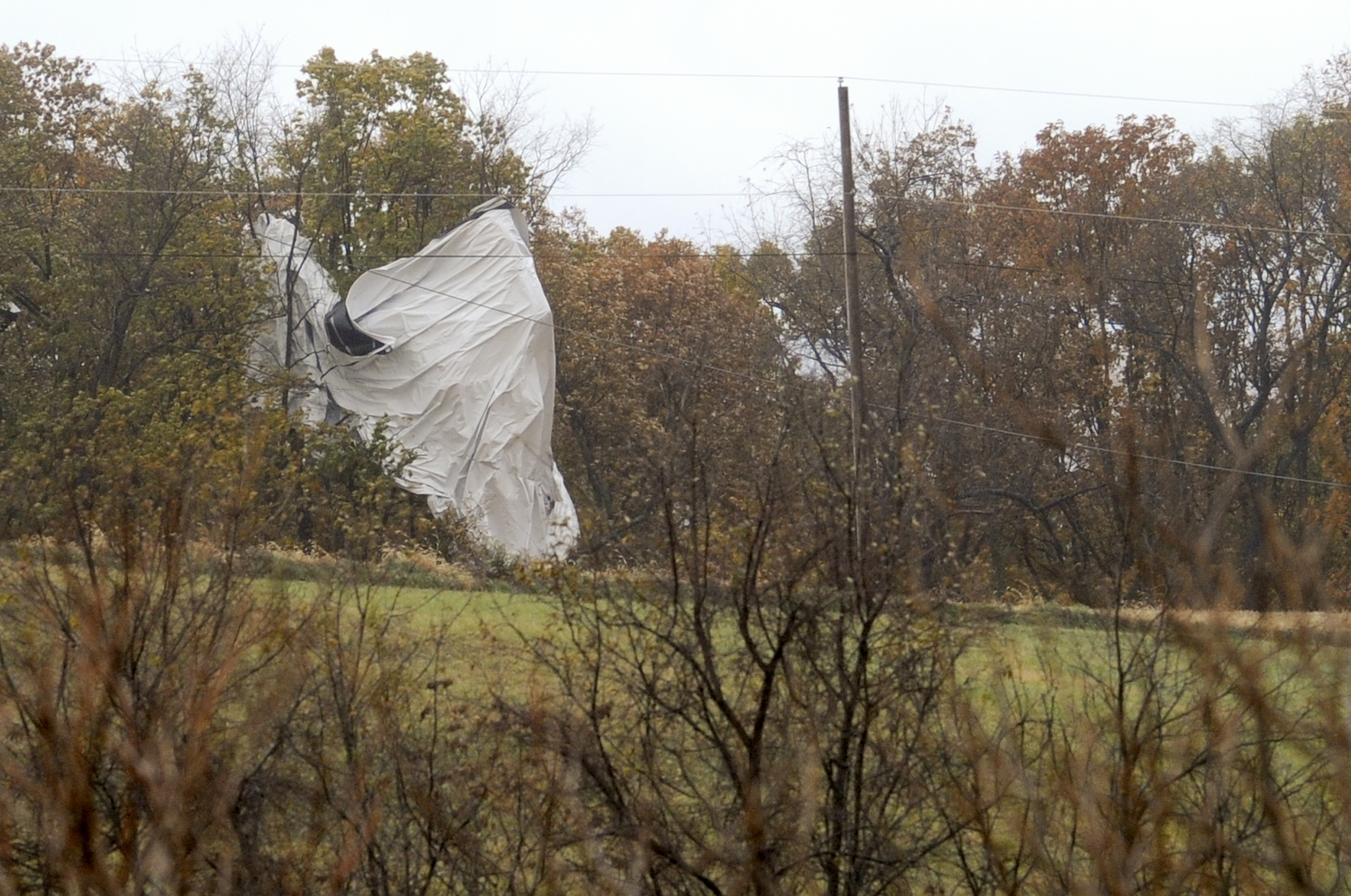 Part of an unmanned Army surveillance blimp hangs off a group of trees after crash landing near Muncy, Pa. on Oct. 28, 2015. (Jimmy May—AP)
