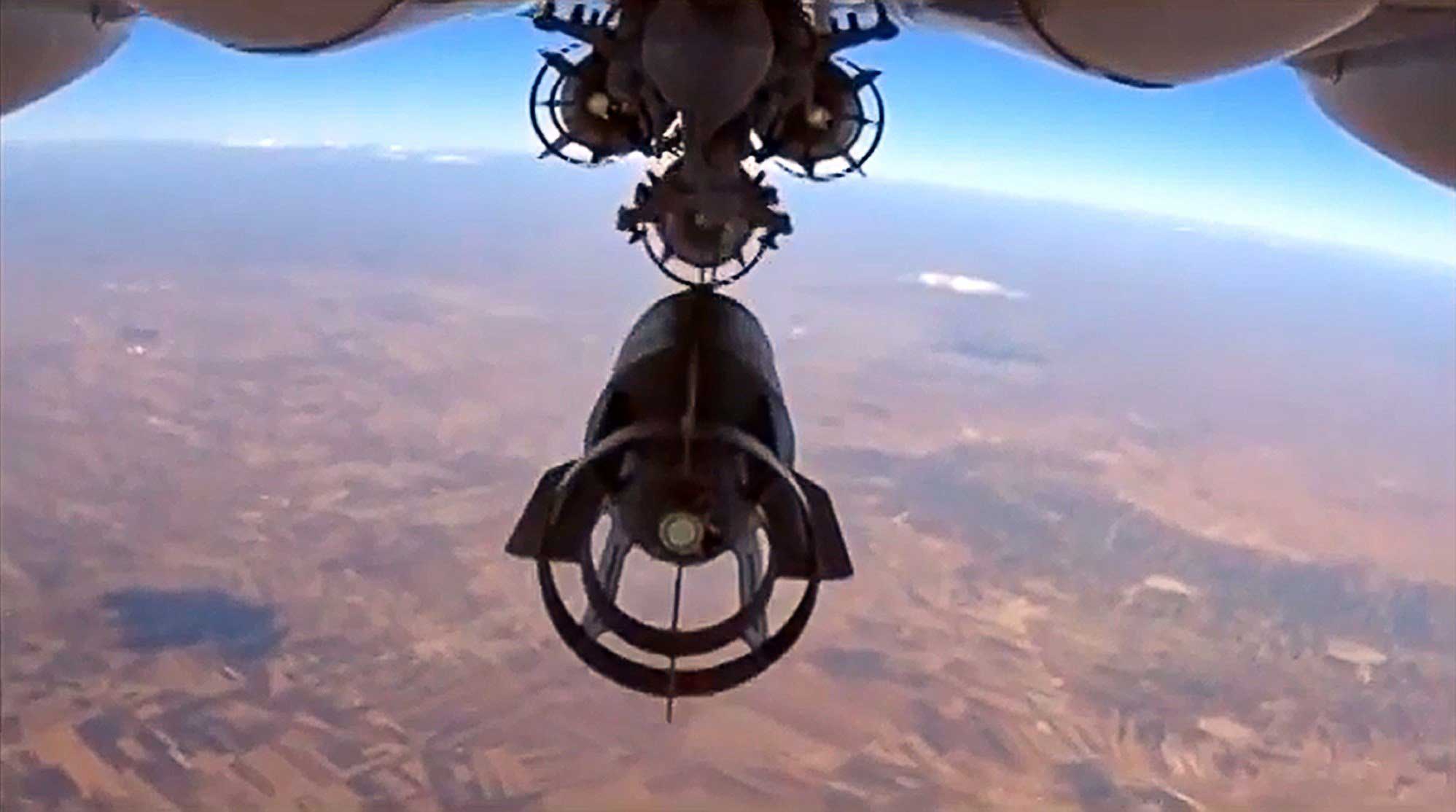 A video grab made on Oct. 6, 2015, shows an image taken from footage made available on the Russian Defense Ministry's official website on Oct. 5, purporting to show a Russia's Su-24M bomber dropping bombs during an airstrike in Syria. (Russian Defence Ministry/AFP/Getty Images)