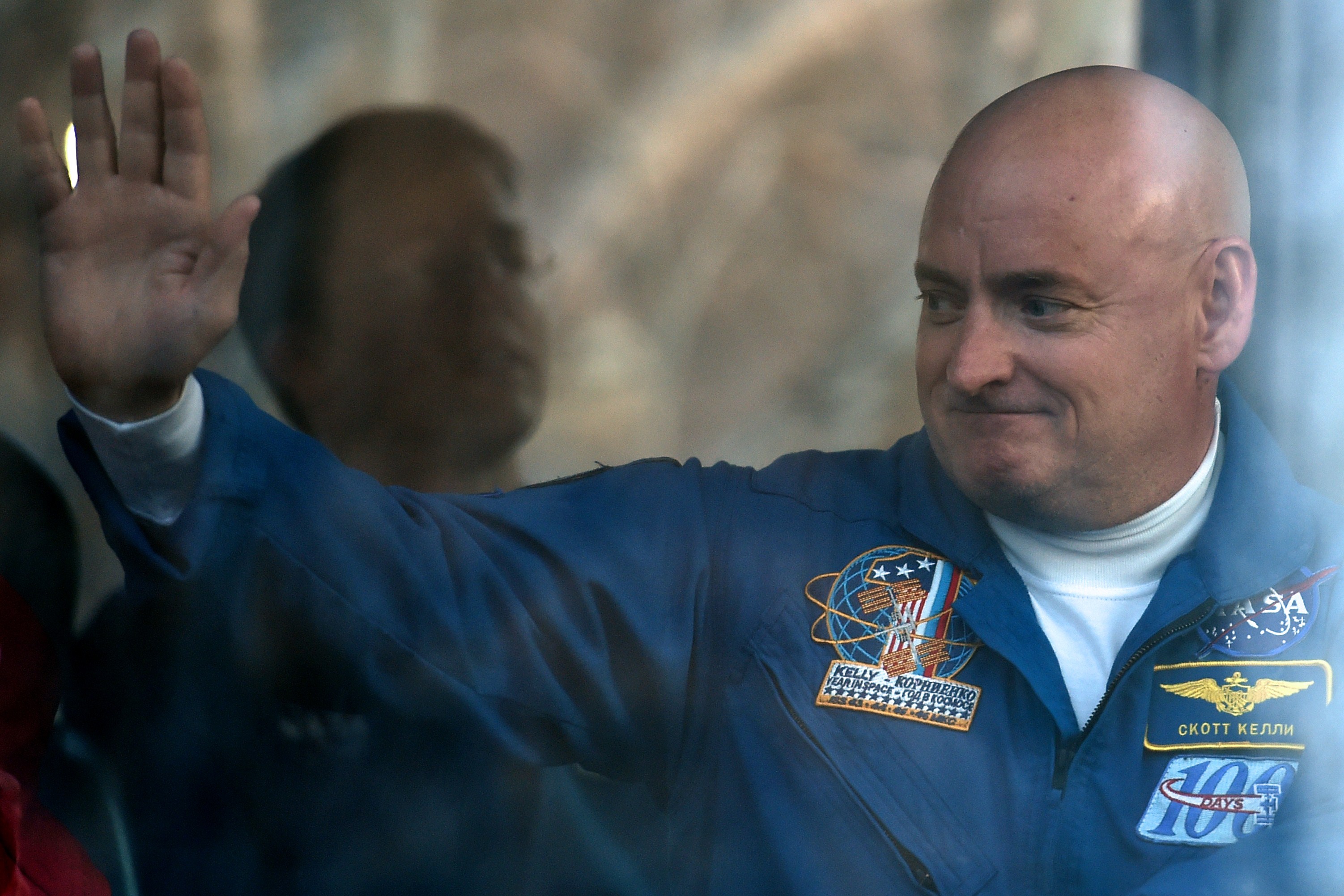 Scott Kelly waves from a bus during a sending-off ceremony in the Russian-leased Baikonur cosmodrome late on March 27, 2015. (Kirill Kudrayavtsev—AFP/Getty Images)
