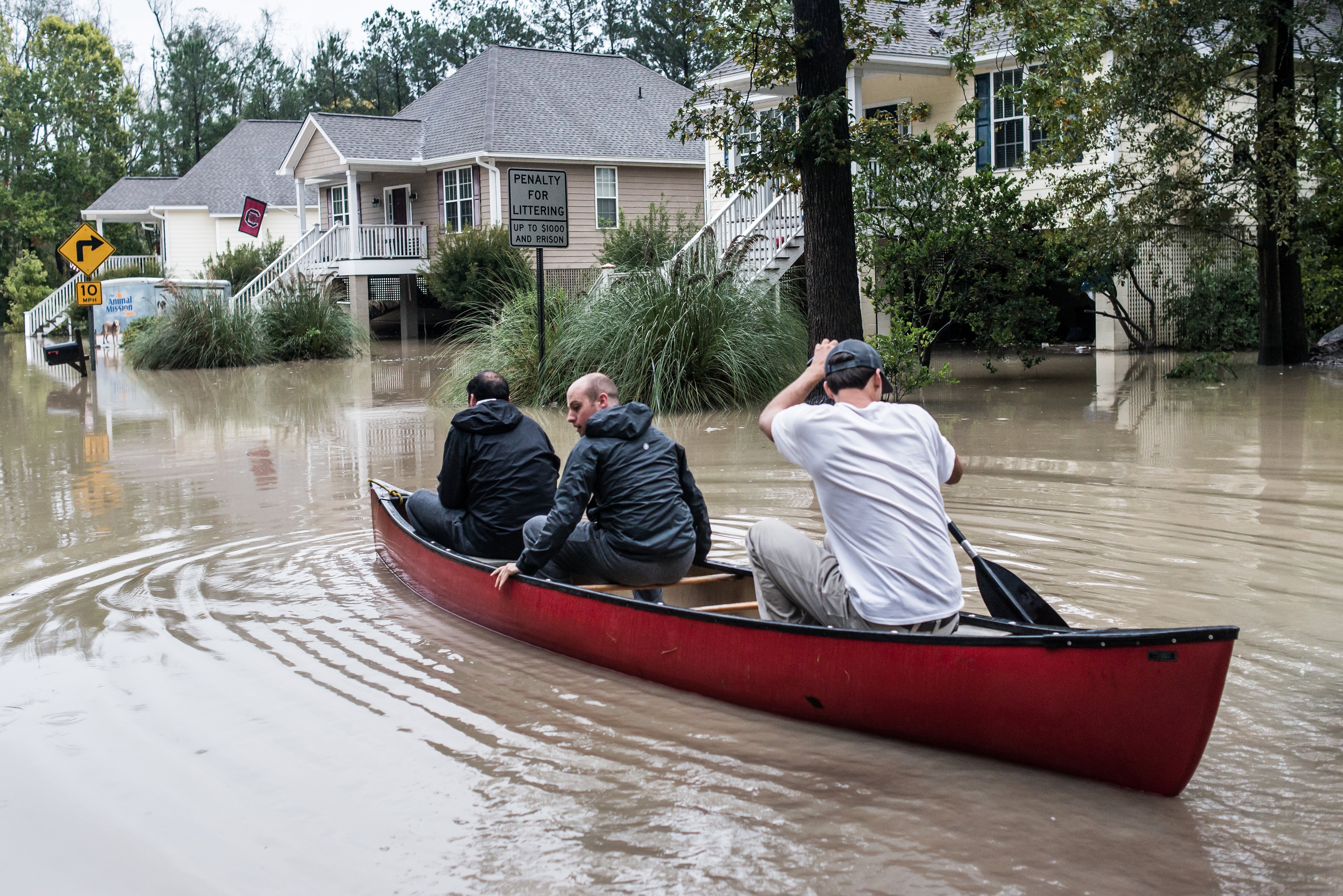 Tyler Bahnmuller, Will Brennan and  Matt Talley take a canoe to investigate following flooding in the area in Columbia, S.C., on Oct. 5, 2015. (Sean Rayford—Getty Images)