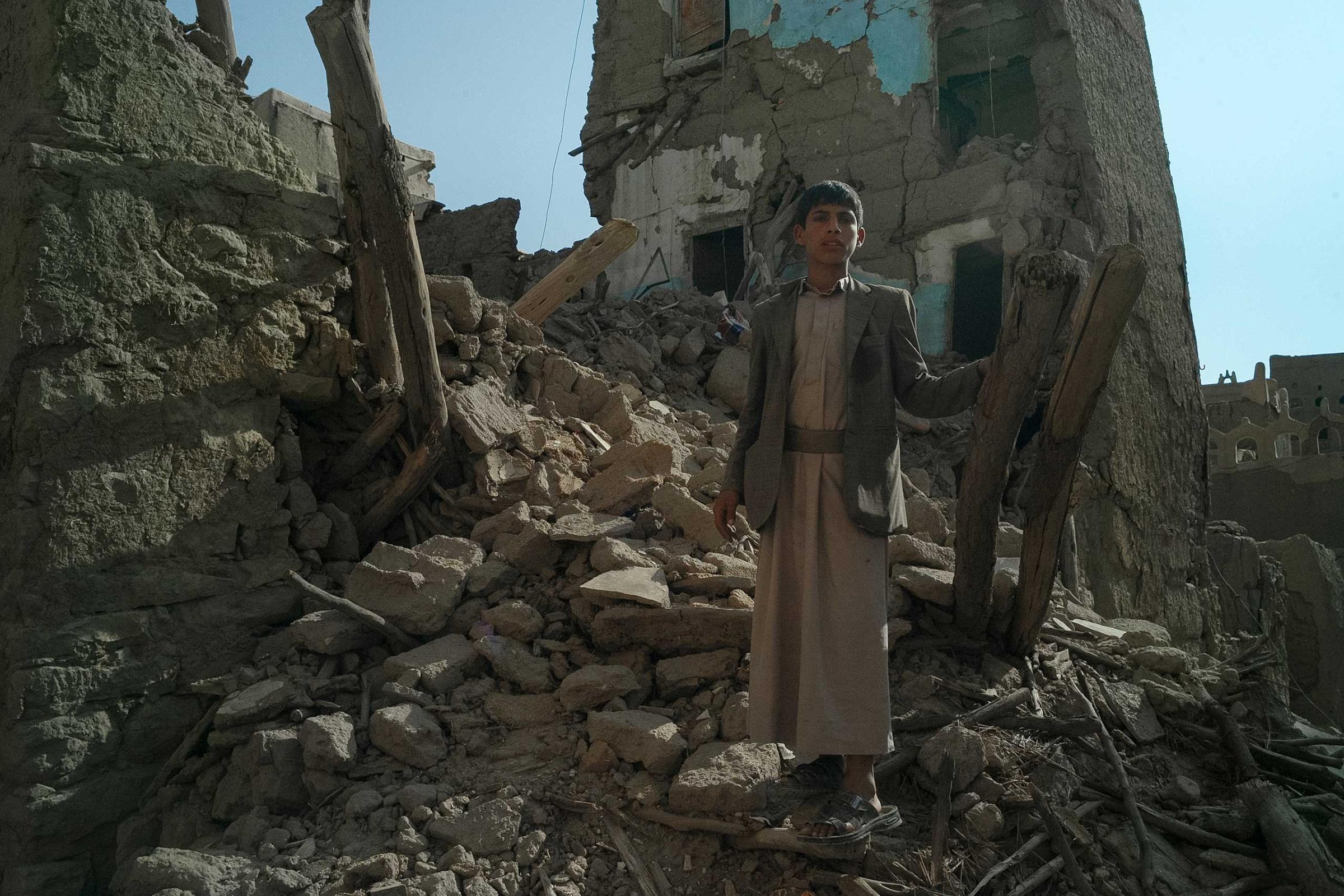 Abdul Bassat, 12, stands at the place where the house of his aunt used to be. His neighbourhood of mud-briks ancient buildings in Rahban, the area on the outskirts of Sa’dah city was destroyed by several Saudi-led airstrikes in May, 2015. Sa’dah province is the stronghold of the Houthi insurgency movement in Yemen, which emerged here in 2004. In 2004-2010 it experienced six wars launched by the Ali Abdullah Saleh government against the Houthi rebels. Rahban area, as well as old Sa’dah city, are included on Yemen’s World Heritage Tentative List.
