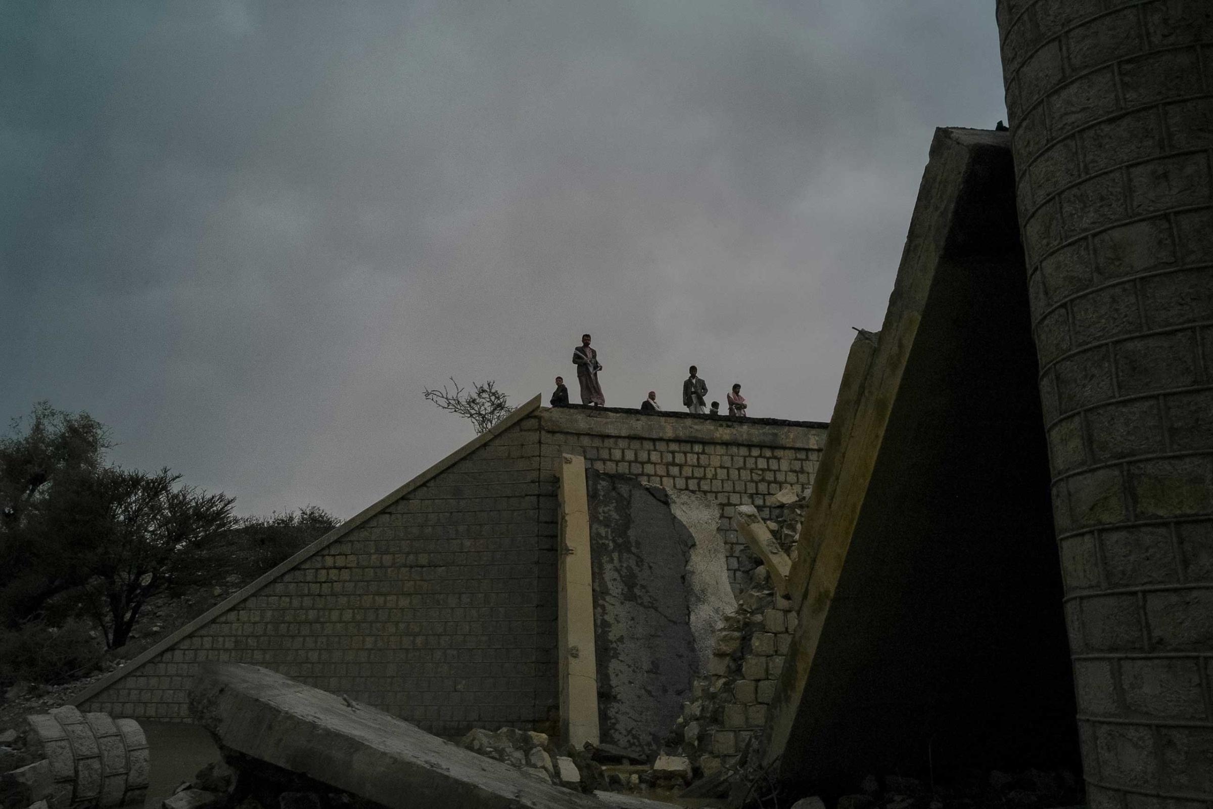 Locals seen on the edge of the bridge, destroyed by airstrike in May 2015 in Sa’dah province, North of Yemen.