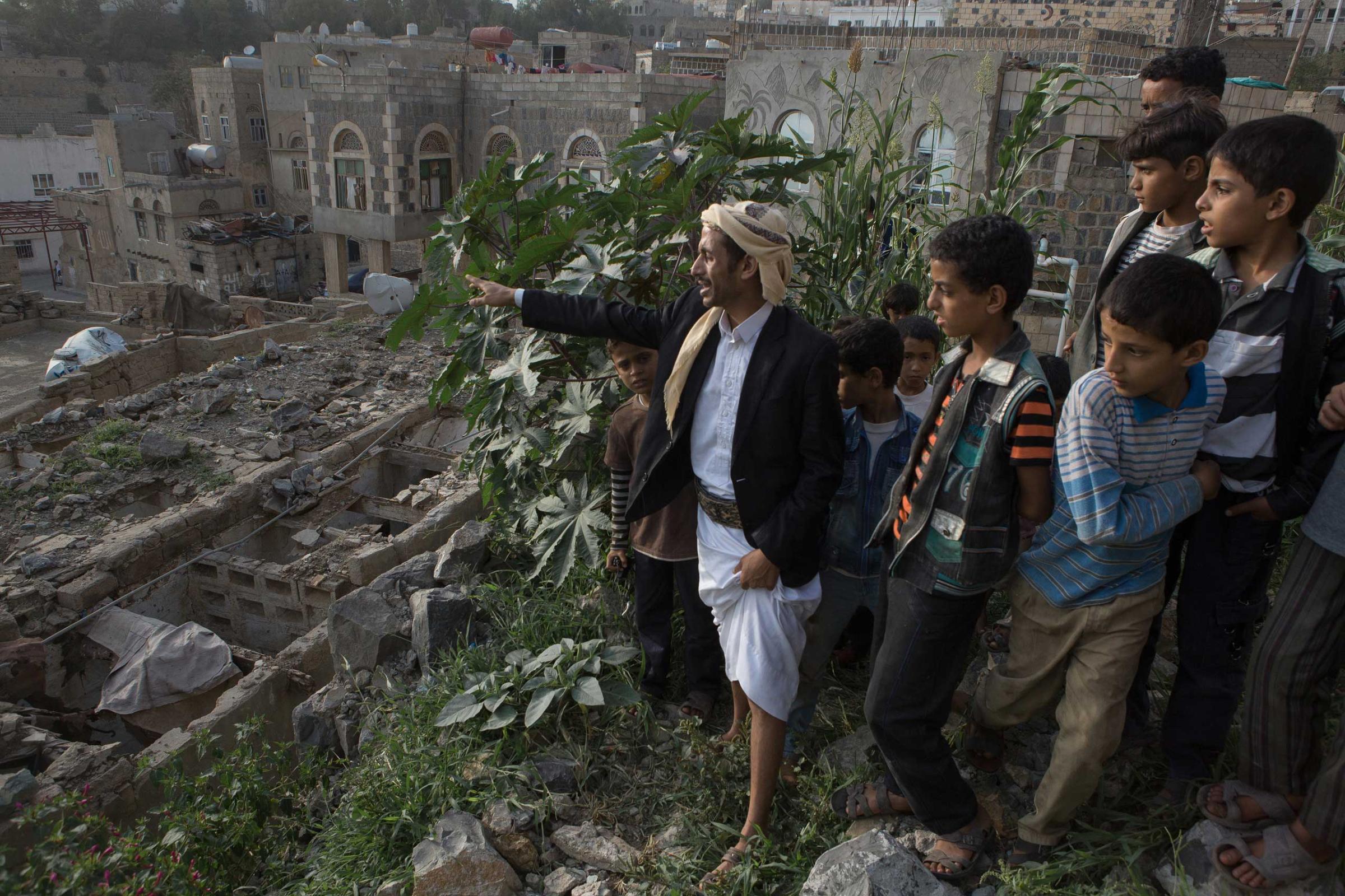 Locals show the destroyed civilian area near a military compound in Hajjah city, which was hit by an airstrike on May, 31 2015 causing 5 civilian casualties.