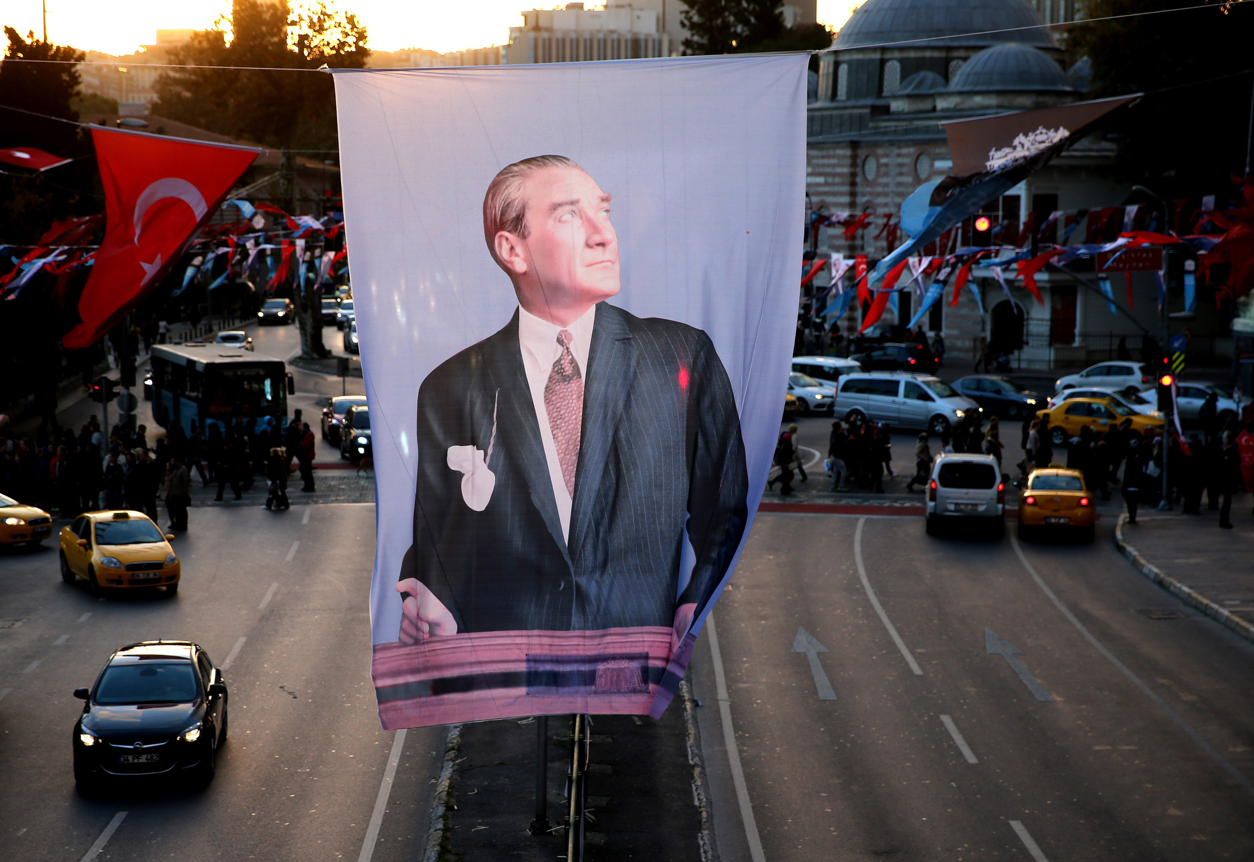 A portrait flag of the Turkish Republic founder Mustafa Kemal Ataturk hangs in Besiktas square, in Istanbul, Saturday, Oct. 31, 2015. Turkish political parties are making their closing appeals ahead of Sunday Nov. 1 crucial parliamentary vote. The election is a redo of June elections in which the ruling Justice and Development Party, or AKP, lost its majority after 13 years of single-party rule.(AP Photo/Hussein Malla)