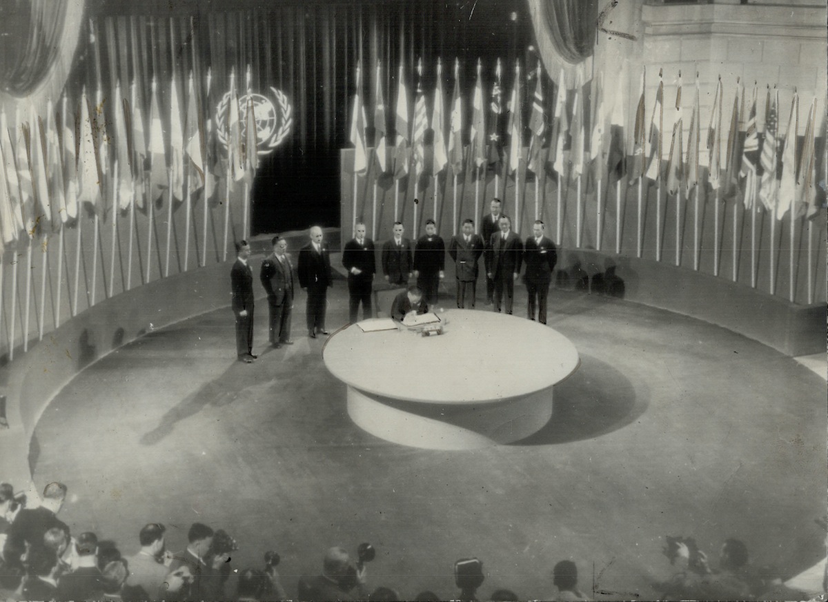 The historic Room where the United Nations security charter was signed is seen in this general view with members of the Chinese delegation lined up while Dr. W. K. Wellington Koo signs the charter for this country on June 27, 1945. The room is in the San Francisco Veterans building. (Toronto Public Library / Getty)