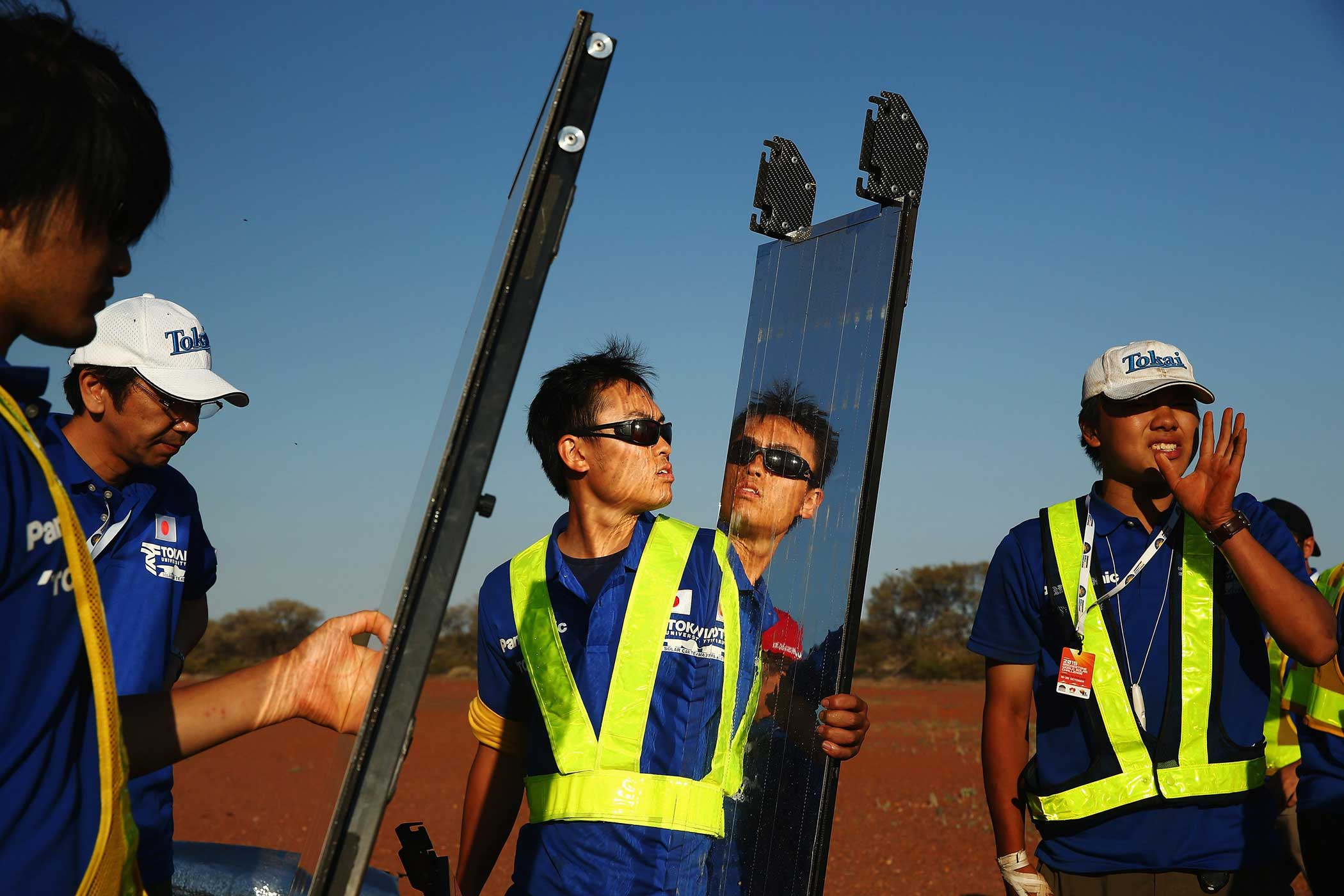 Members from Tokai Challenger of Tokai University Japan catch the last of the sun to charge at the end of racing  in the Challenger Class on Oct. 20, 2015 outside of Coober Pedy, Australia.