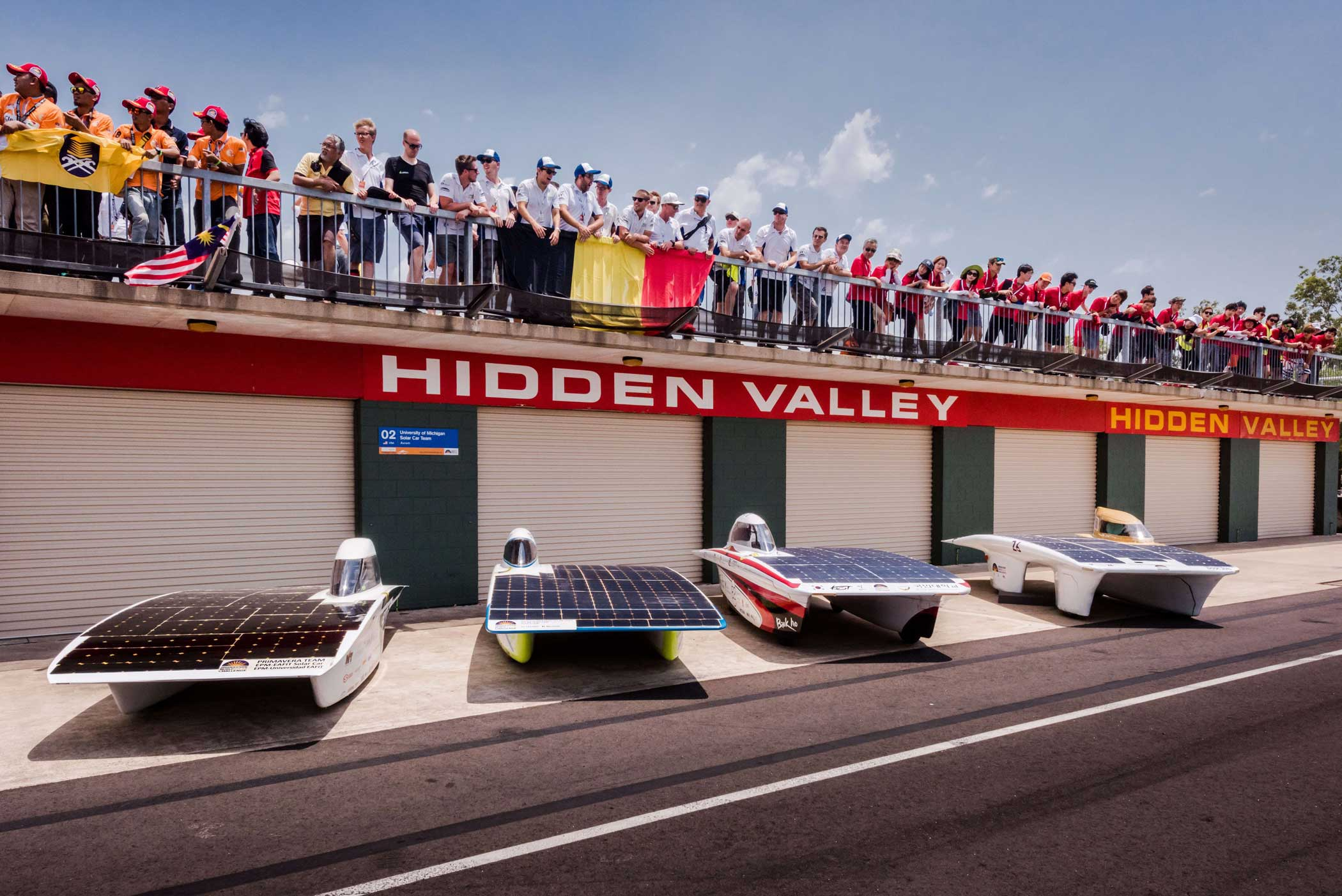 Punch Powertrain Solar Team shows team members posing above their cars after the qualification lap for the 2015 Bridgestone World Solar Challenge at Hidden Valley race track in Darwin on Oct. 18, 2015.