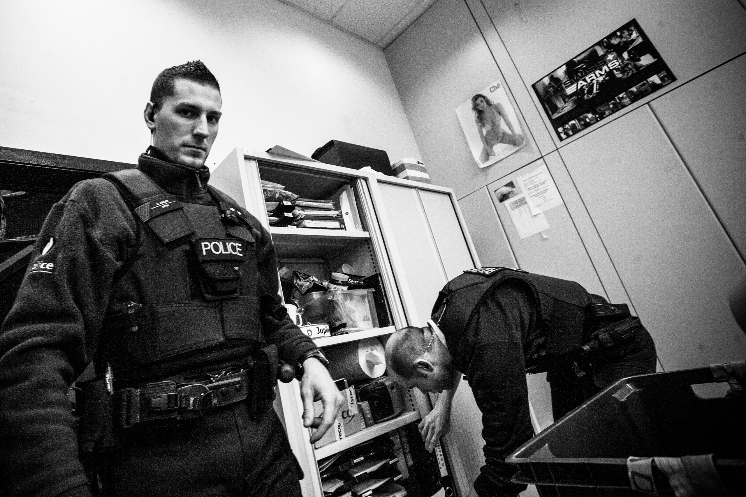 Cops are preparing documents they will work on during the night, Molenbeek, Brussels, Belgium. Feb. 1, 2010.