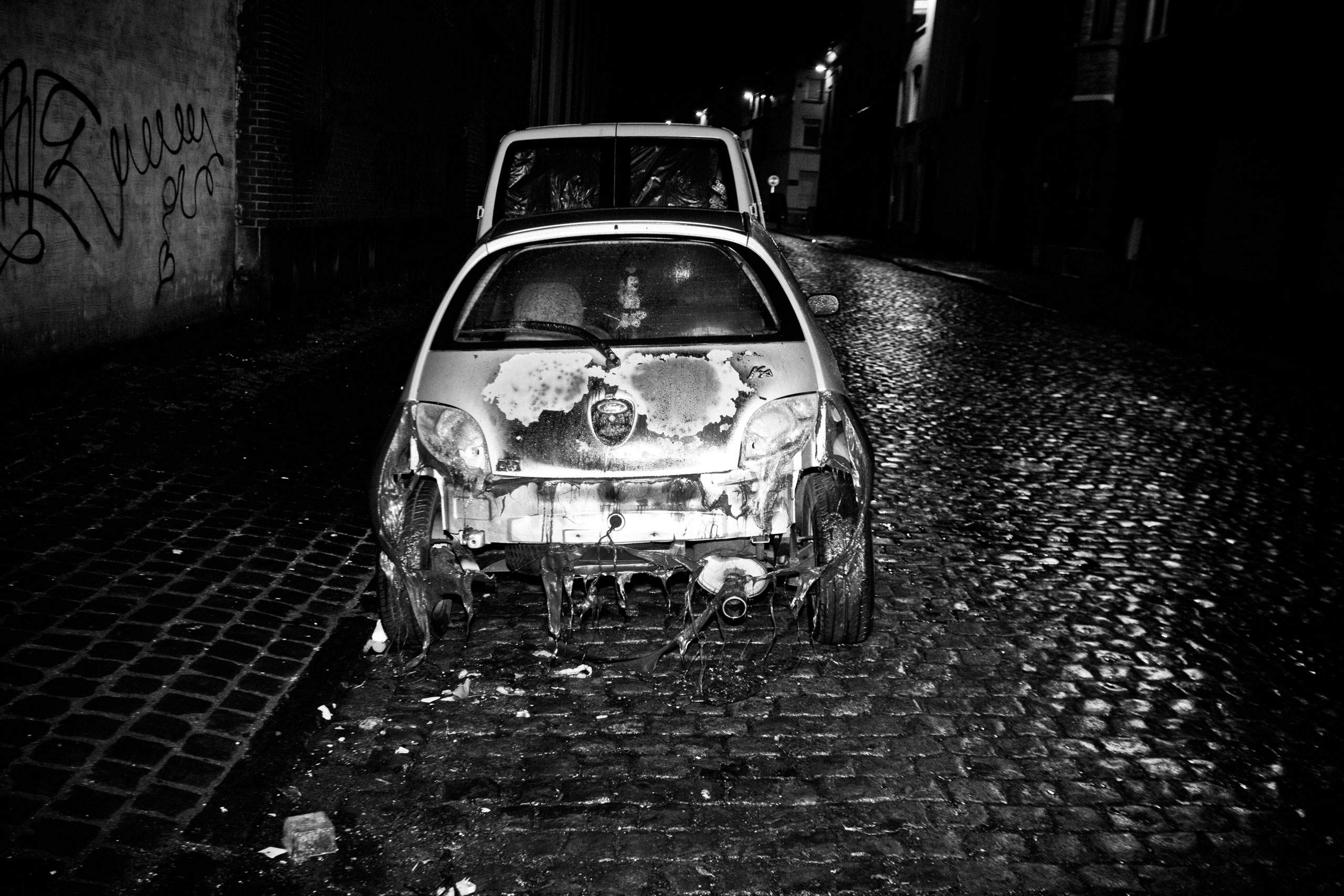A burned car in the streets of Molenbeek, Brussels. Jan. 28, 2010.