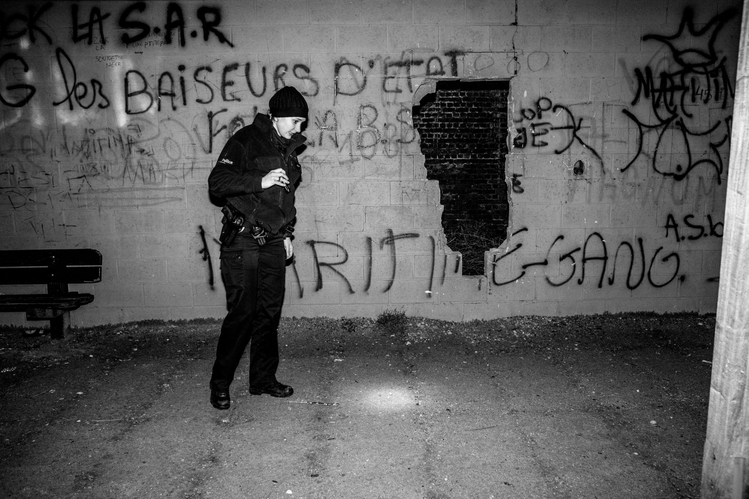 A policewomen searching for evidence in the bad area of Molenbeek, Brussels, Belgium on February 2011
