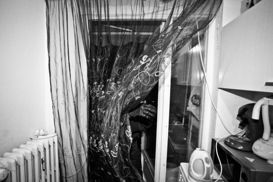 A policeman enters in the kitchen of a private home follwing a call for a family fight in Molenbeek, Brussels on December 2011.