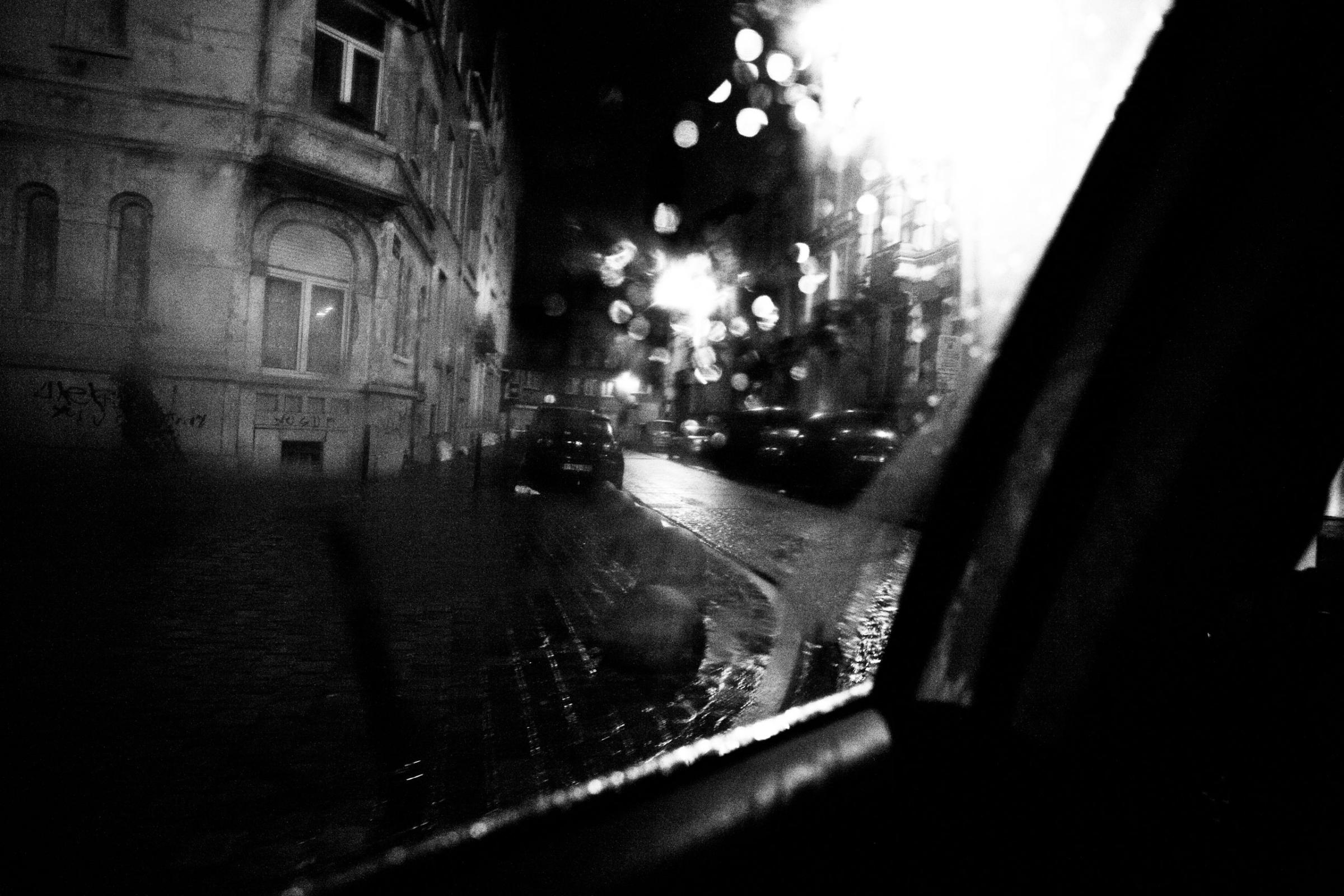 View from the window of the back seat of a police car driving trough the city of Molenbeek, Brussels Ouest District, Belgium on December 2011.