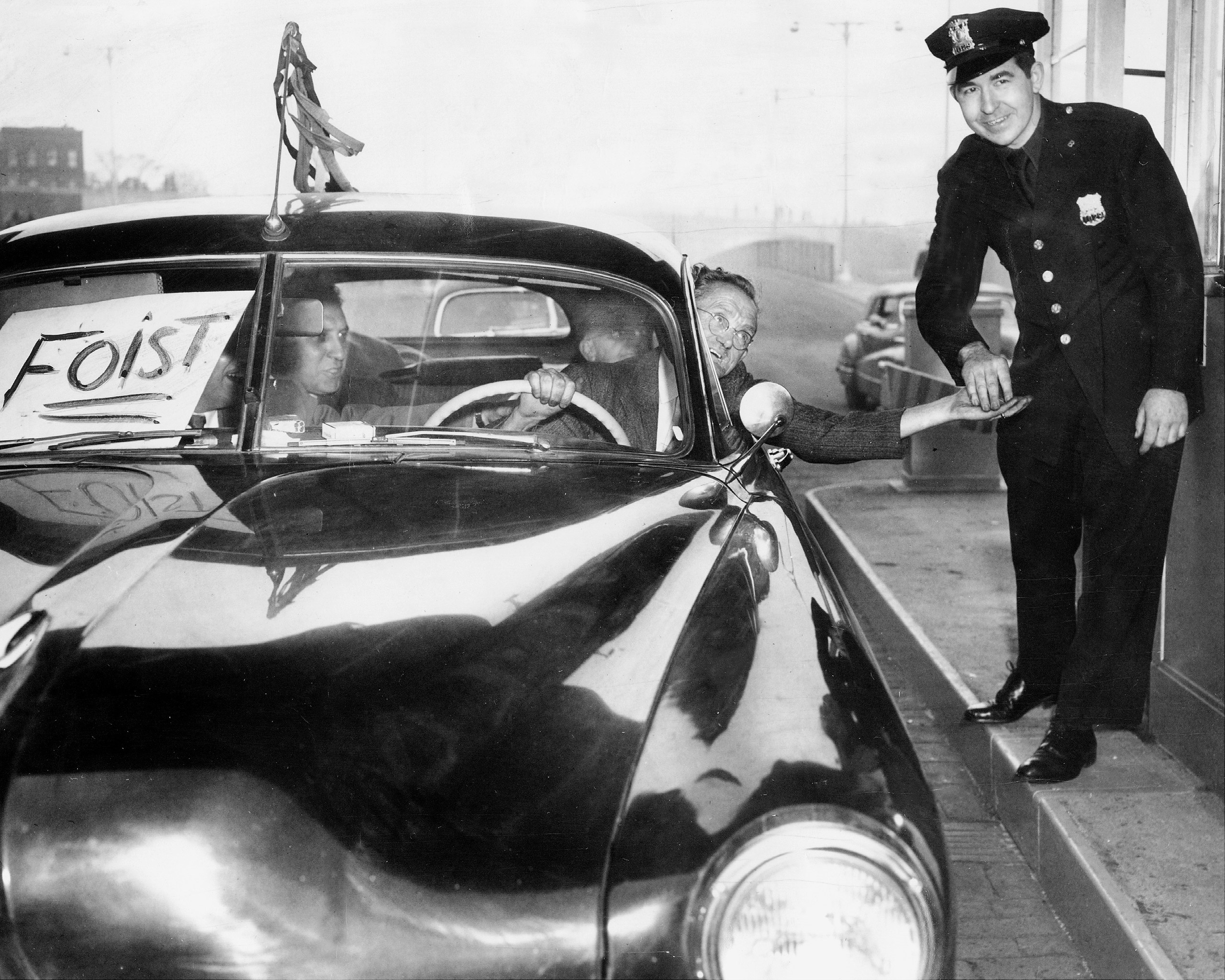 May 25, 1950:  Cop grins broadly as driver of one of the first cars to enter the Brooklyn end of the Brooklyn Battery Tunnel hands him his ticket.