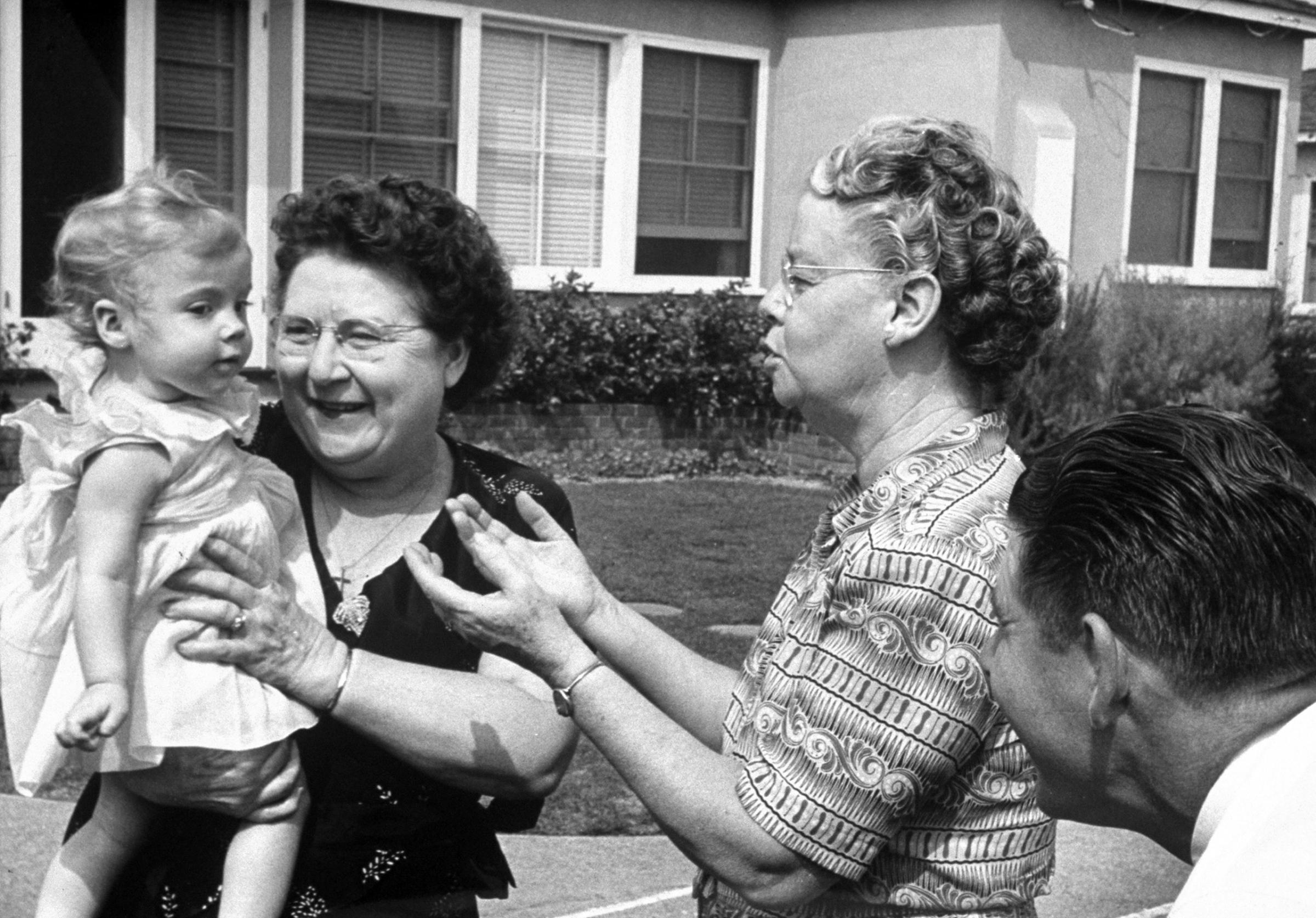 New Grandmothers, Lindy's mother (left), Bernice's take turns admiring Linda on her arrival.