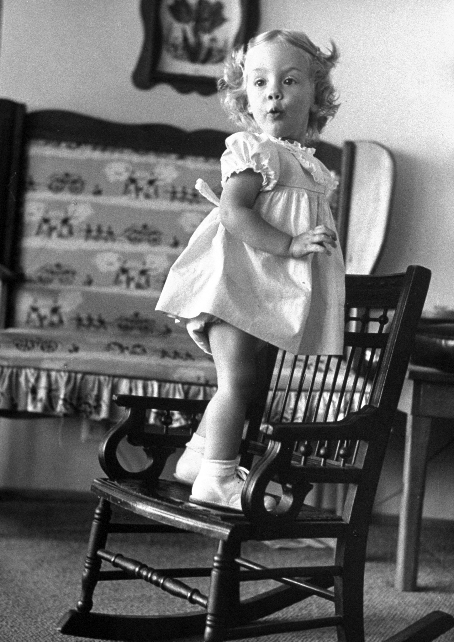 Favorite trick is climbing on a family heirloom given her by Grandmother. Then she stands up in chair to show off.
