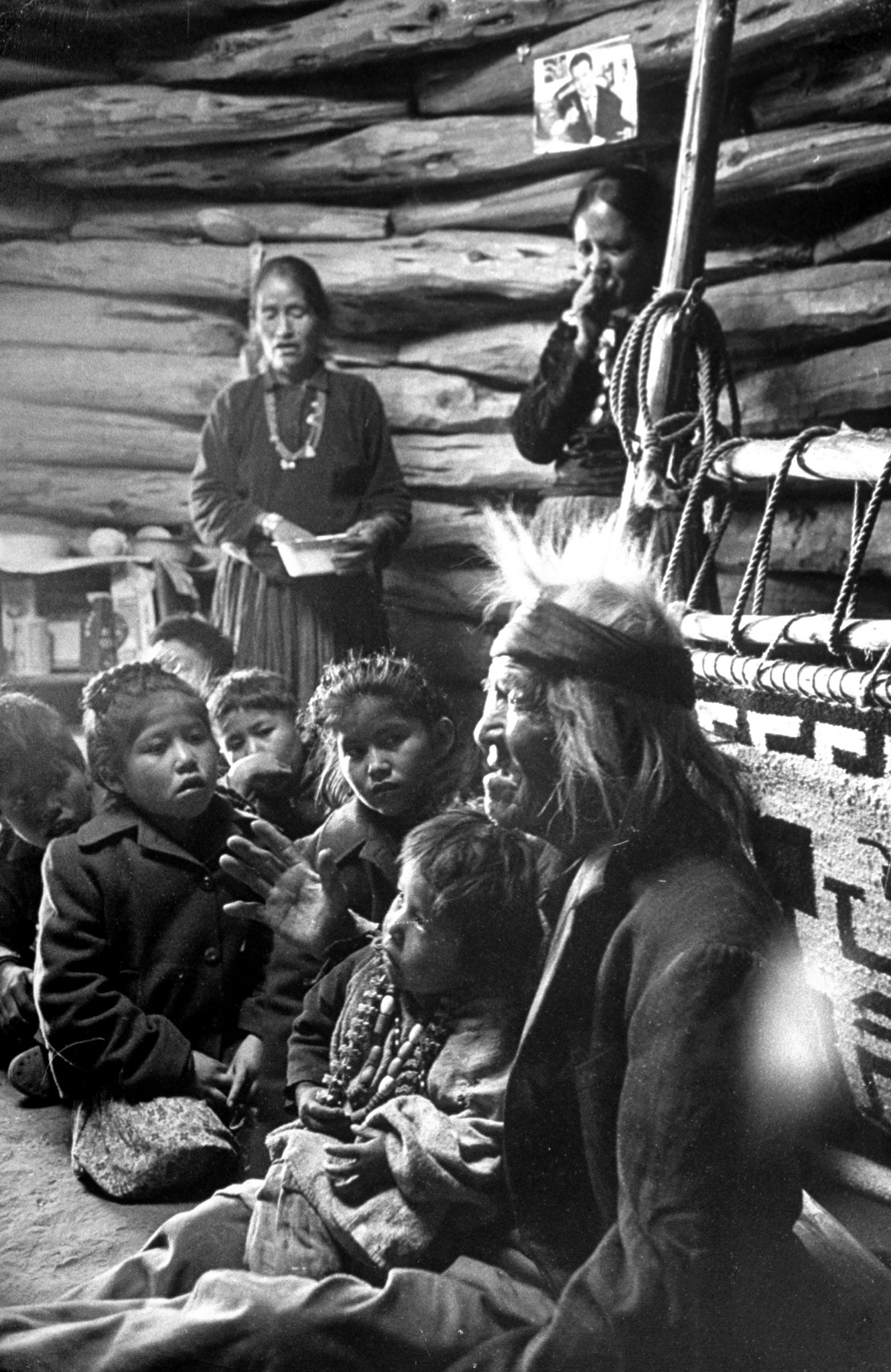 Seated close to the evening fire, old man Gray Mountain, 91, tells his small grandchildren legends about the early days of the Navajo people.