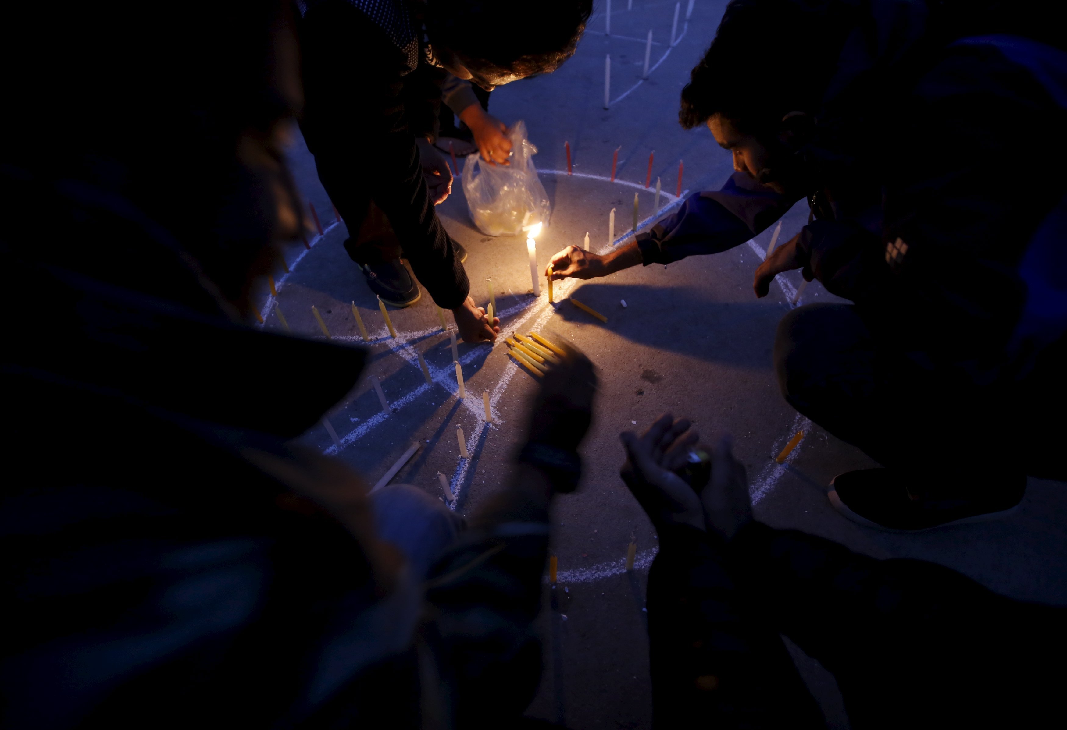 People light candles during a vigil in Kathmandu following the deadly attacks in Paris, on Nov. 15, 2015.