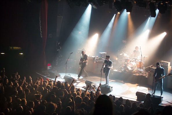 American rock group Eagles of Death Metal perform on stage on Nov. 13, 2015, at the Bataclan concert hall in Paris, few moments before four men armed with assault rifles and shouting <i>"Allahu akbar"</i> ("God is great!") stormed into the venue (Marion Ruszniewski—AFP/Getty Images)