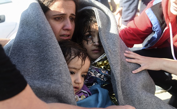 A mother hugs her children after disembarking as migrants and refugees arrive on the Greek island of Lesbos after crossing the Aegean Sea from Turkey on November 15, 2015 (Bulent Kilic—AFP/Getty Images)
