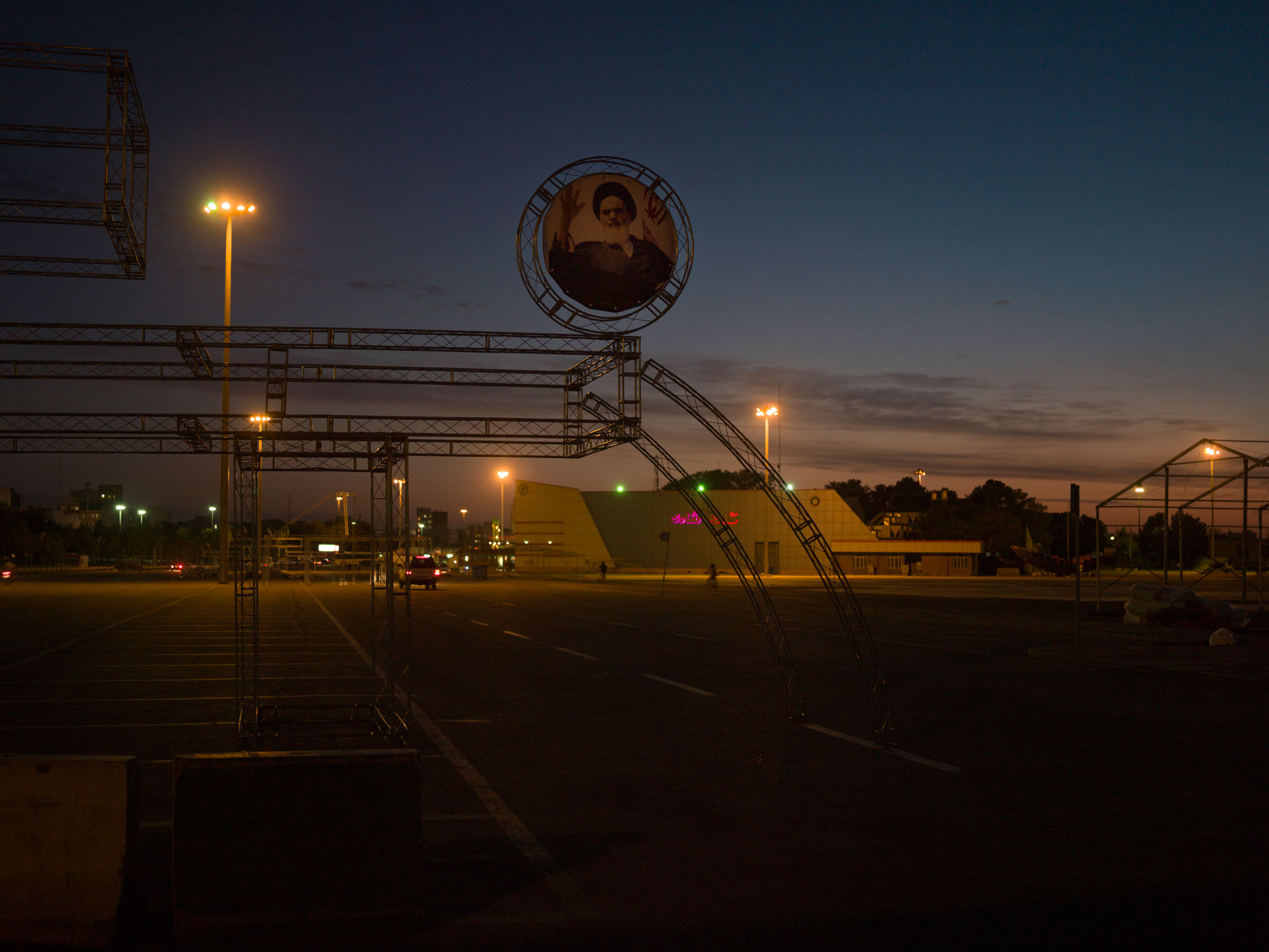 A portrait of  Ayatollah Ruhollah Khomeini, the  founder of the Islamic Republic of Iran, looms over an empty parking lot in Tehran.