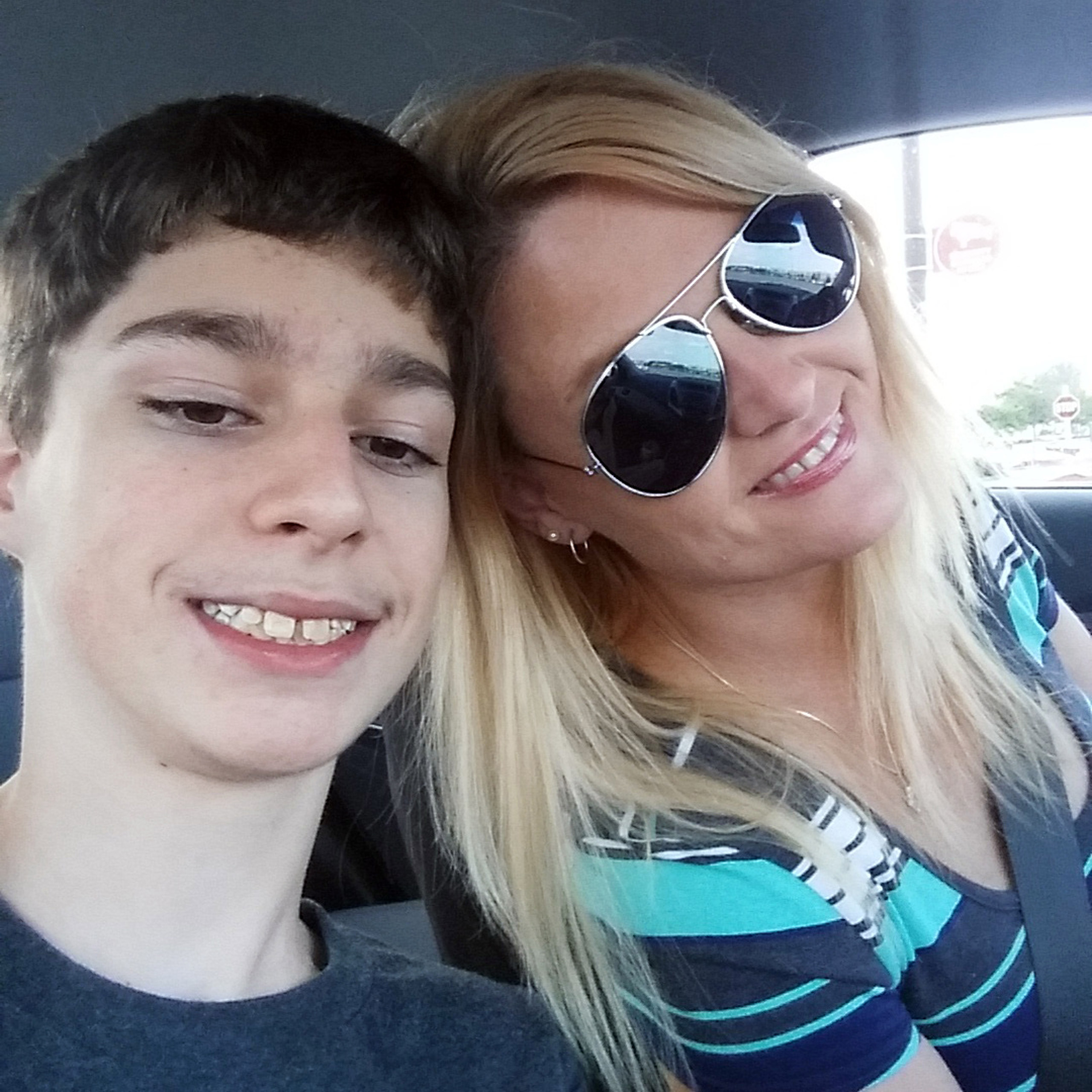 In this undated selfie, Alex Hoover, left, poses for a photo with his mother, Rene. Alex Hoover, an Alabama teen with a terminal heart condition has not returned to school after a spate of hospitalizations because of what his mother says is a dispute with school officials about how he might die. (Rene Hoover via AP)