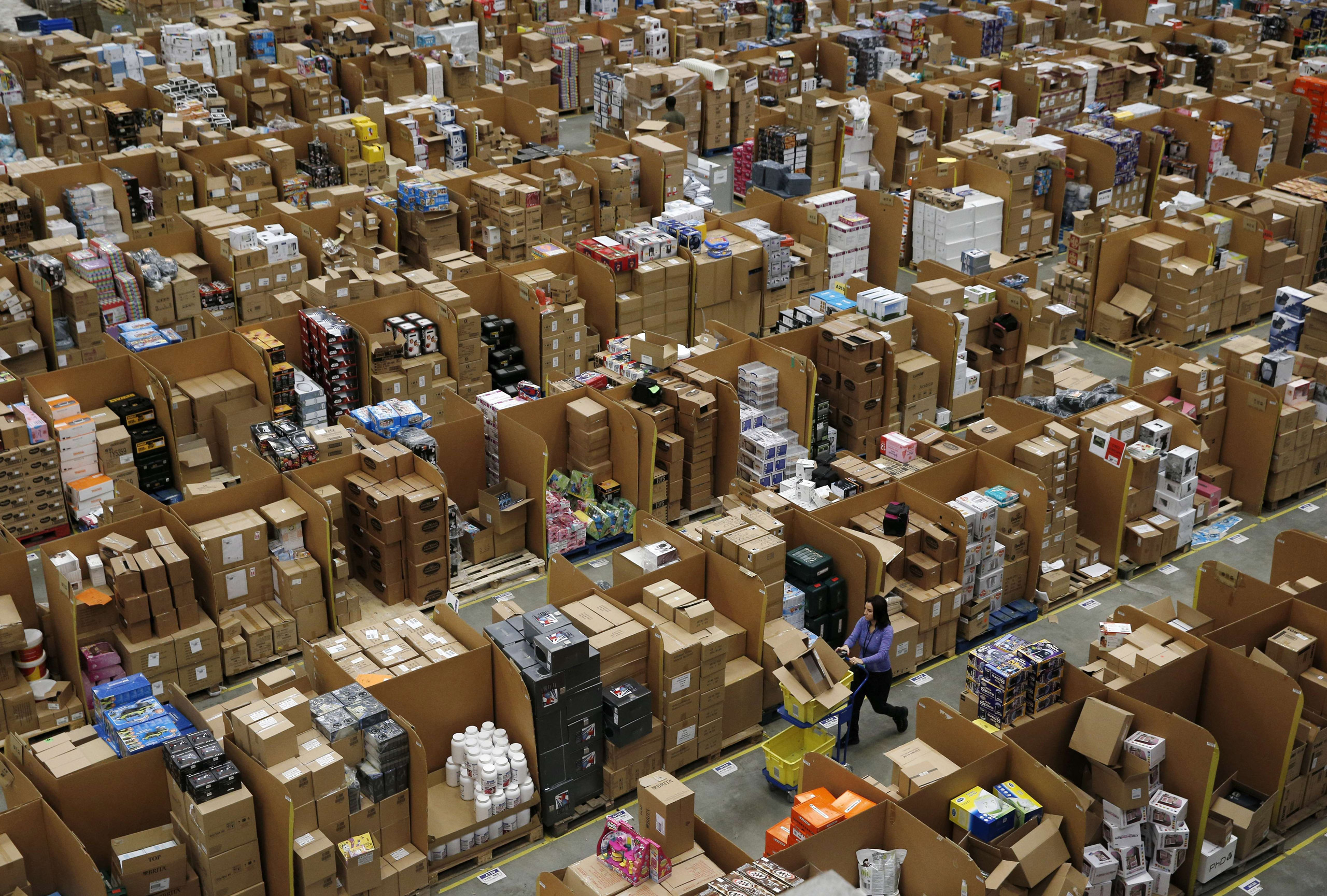 Workers walk along aisles of goods stored inside an Amazon.co.uk fulfillment centre in Hemel Hempstead,U.K., on Nov. 25, 2015. (Adrian Dennis&mdash;AFP/Getty Images)