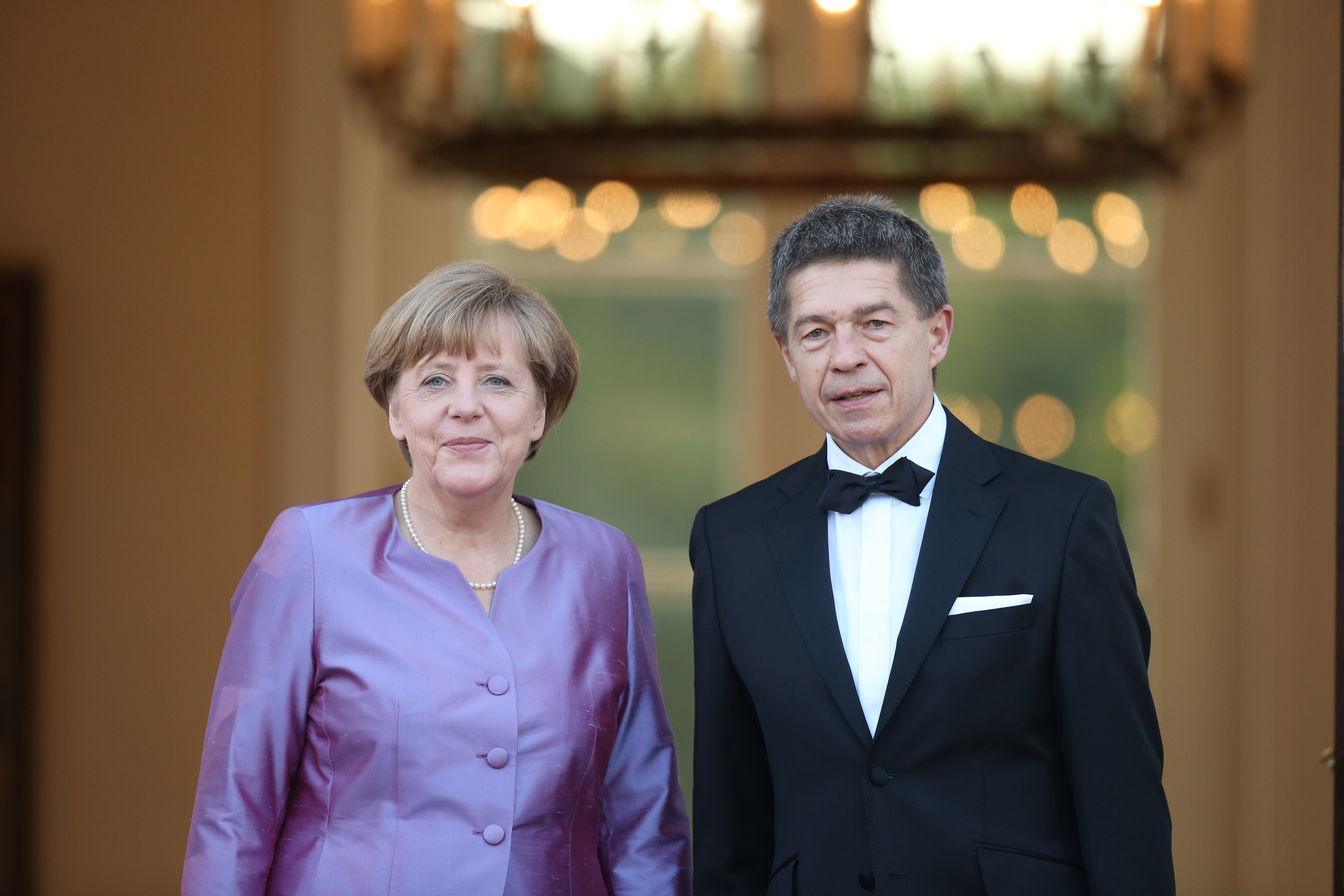 Chancellor Angela Merkel and her husband Joachim Sauer arrive at the Schloss Bellevue Palace on June 24, 2015 in Berlin.