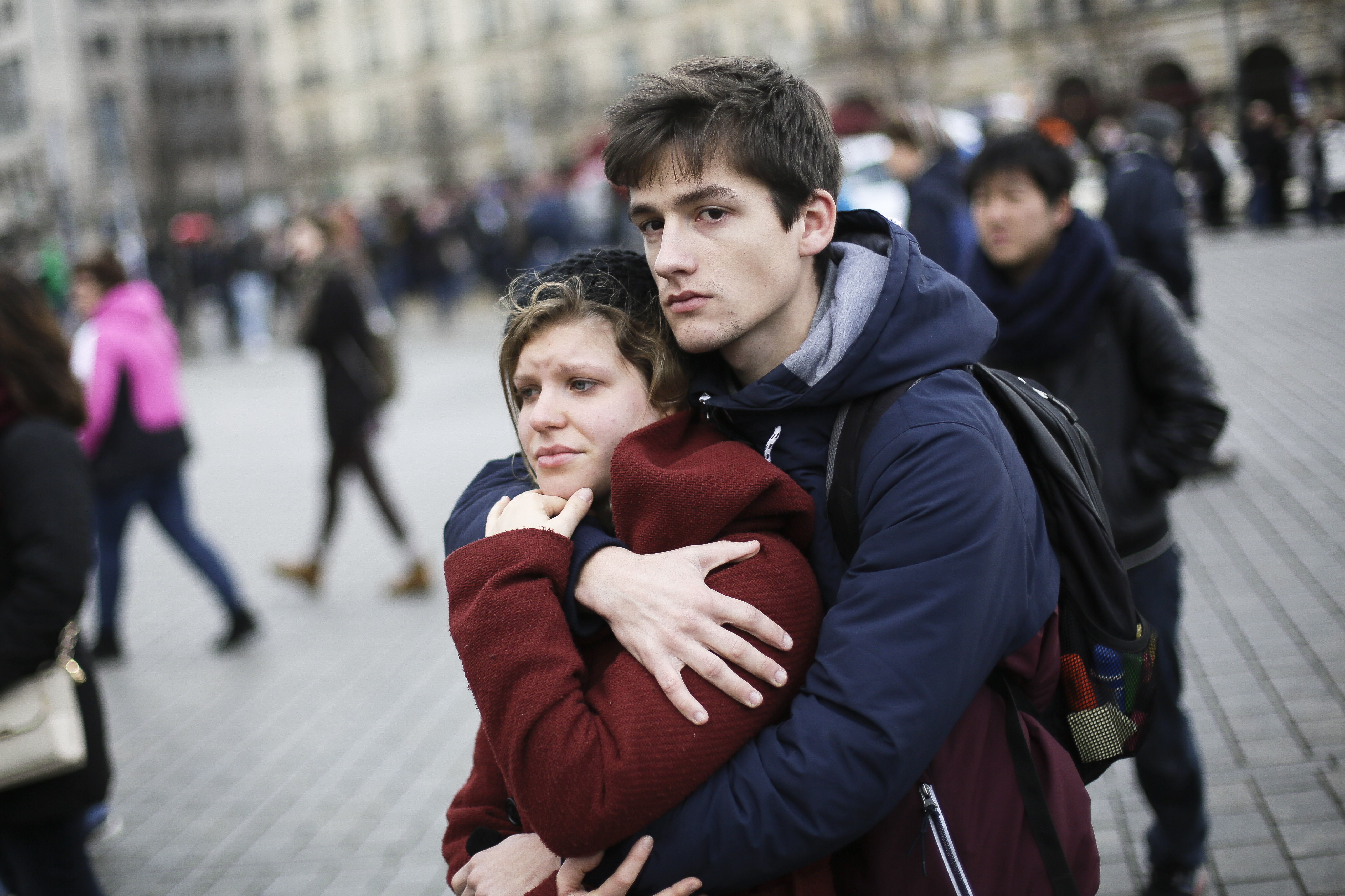 A young couple mourns for the victims killed in Paris, in front of the French Embassy in Berlin on Nov. 14, 2015.