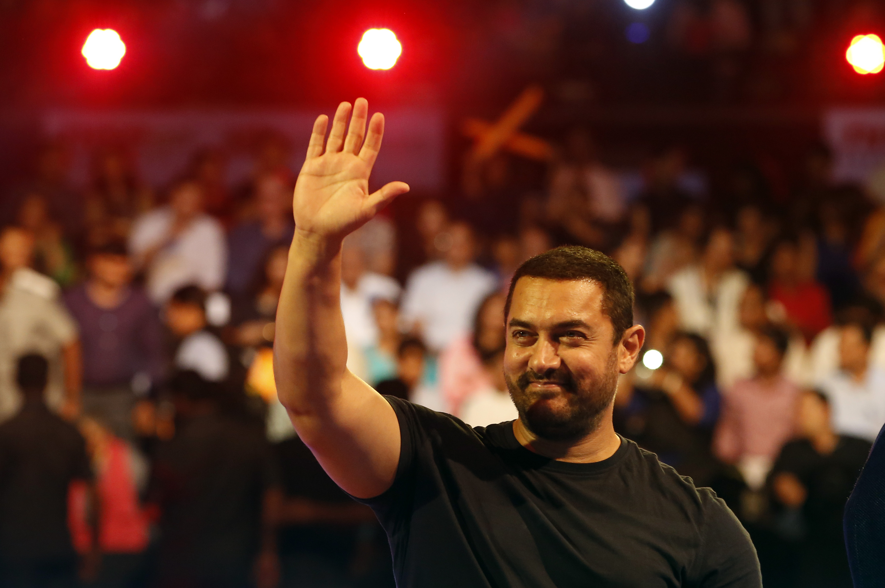 Bollywood actor Aamir Khan waves to the crowd as he attends the inaugural session of Pro Kabaddi League 2015 in Mumbai on July 18, 2015 (Rajanish Kakade—AP)