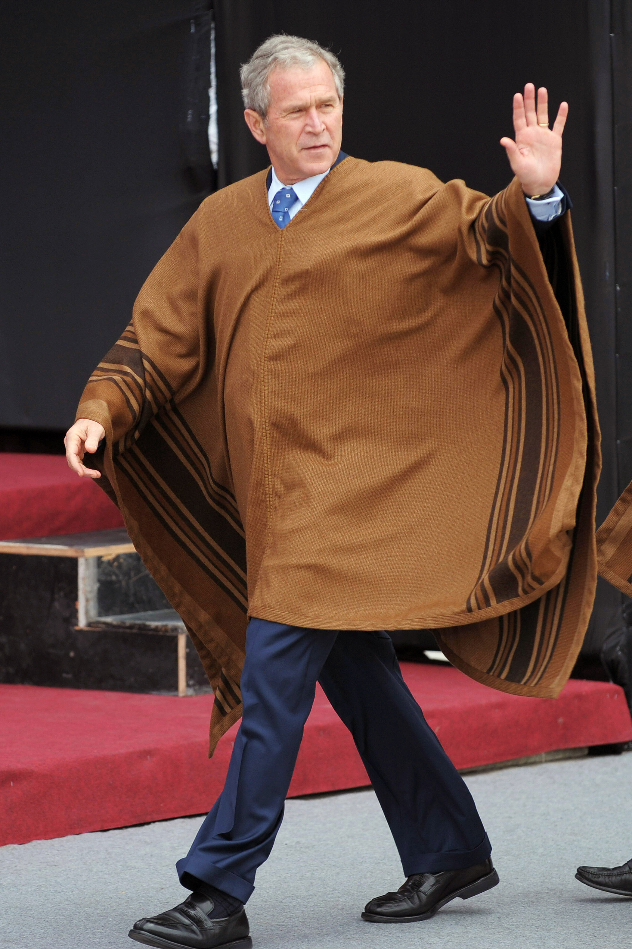 U.S. President George W. Bush, wearing a poncho, arrives for the official photograph for the APEC Summit on Nov. 23, 2008 in Lima, Peru.