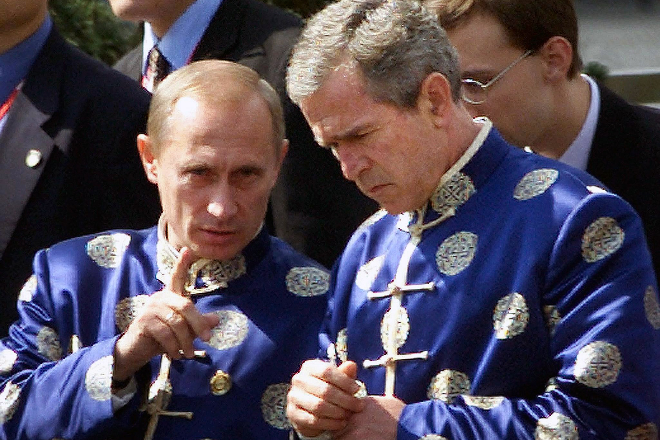 Russian President Vladimir Putin and U.S.President George W. Bush wear traditional Chinese silk coats at the APEC Summit in Shanghai on Oct. 21, 2001.