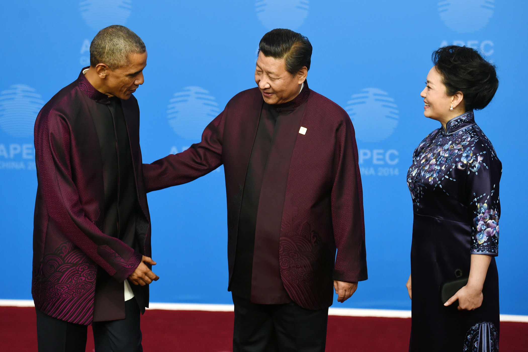 U.S. President Barack Obama is greeted by Chinese President Xi Jinping and his wife Peng Liyuan as he arrives for the APEC Summit banquet in the Chinese capital Beijing on Nov. 10, 2014.