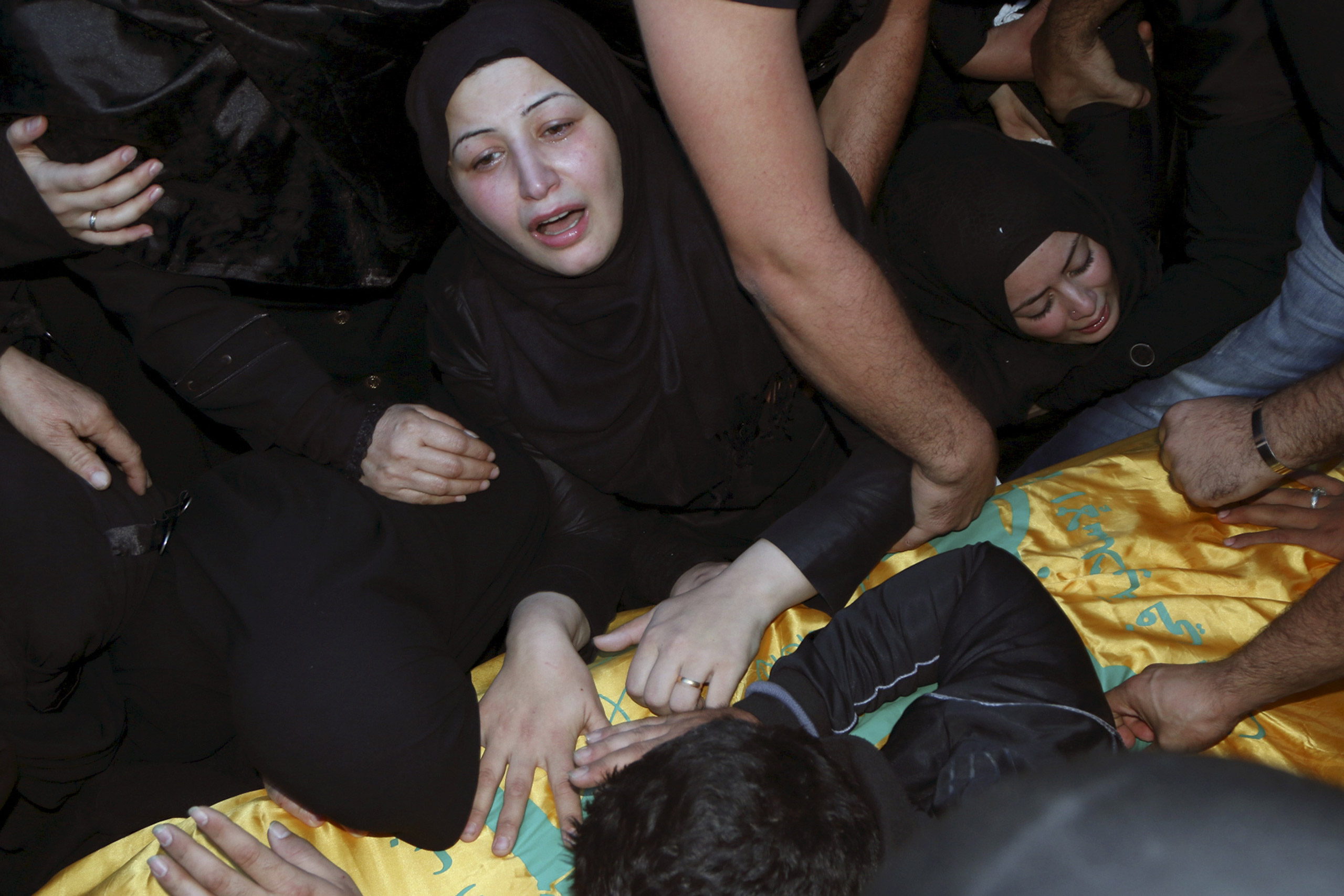 Relatives mourn over the coffin of Hezbollah member Adel Akram Termos, who was killed in the two explosions that occurred on Thursday in Beirut's southern suburbs, during his funeral in Tallousa, southern Lebanon, on Nov. 13, 2015. (Karamallah Daher—Reuters)