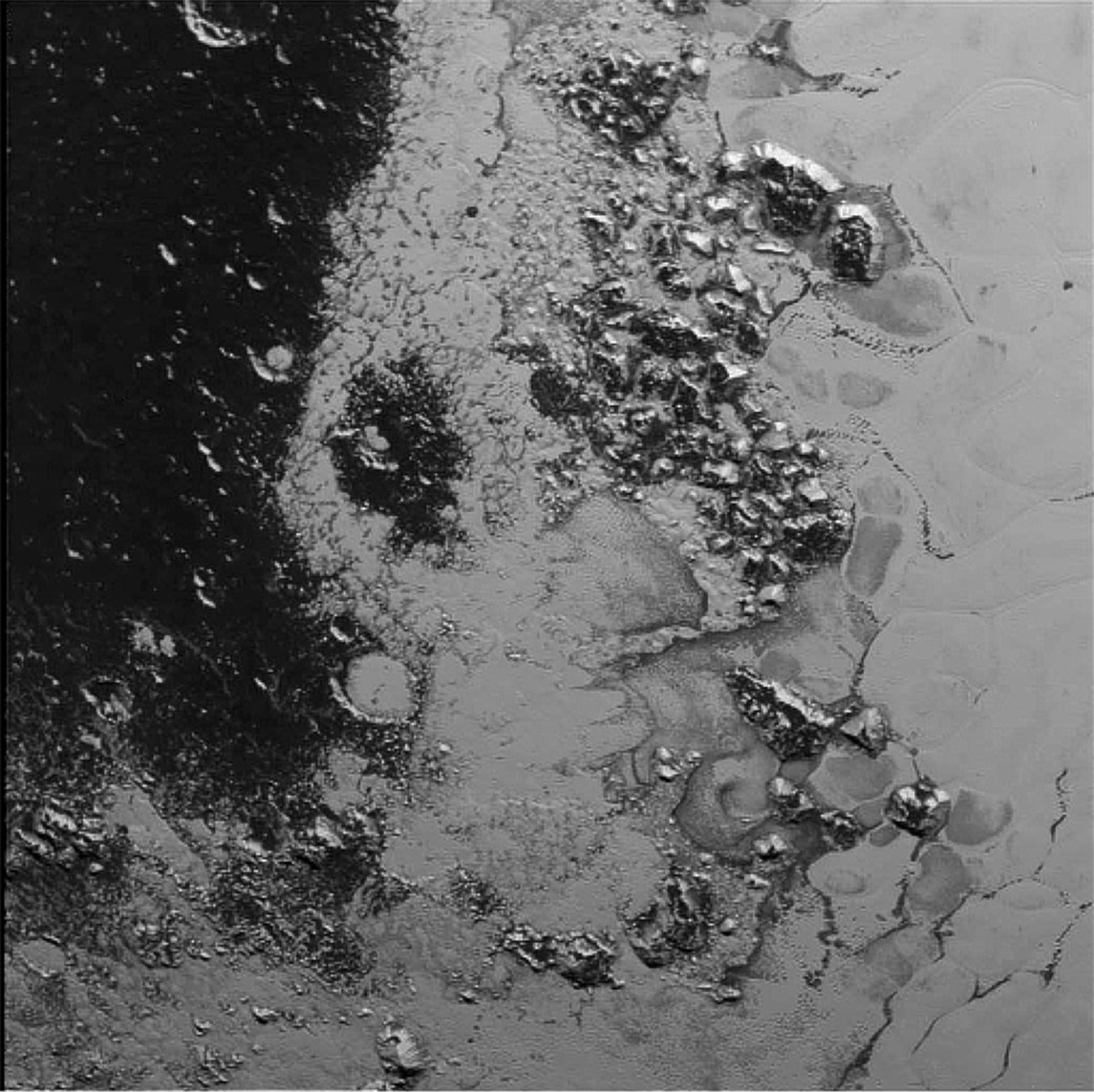 This photo shows the new mountain range discovered by NASA’s New Horizons spacecraft on July 14, 2015 on Pluto, in a heart-shaped region named Tombaugh Regio.