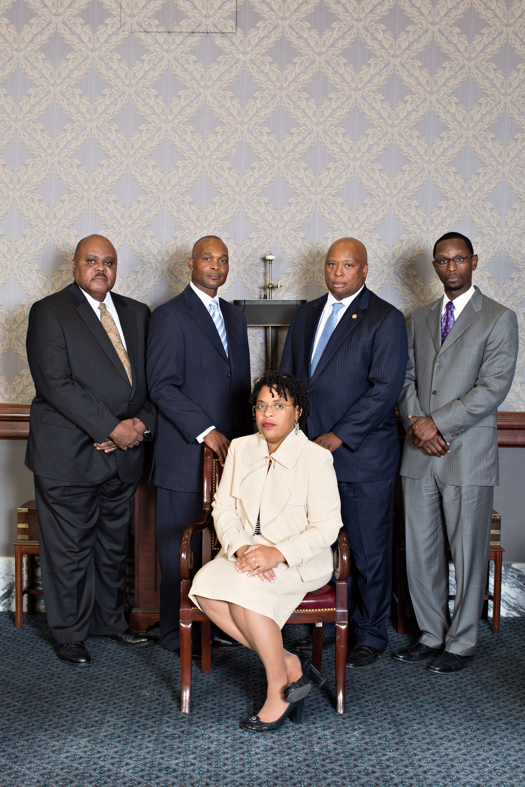 Jennifer Pinckney with (from left) Representative Joe Neal, the Rev. Chris Vaughn, the Rev. Kylon Middleton and Senator Gerald Malloy
                              
                              The Rev. Clementa Pinckney’s four best friends, photographed with his widow at the South Carolina State House, have guarded the family in his absence