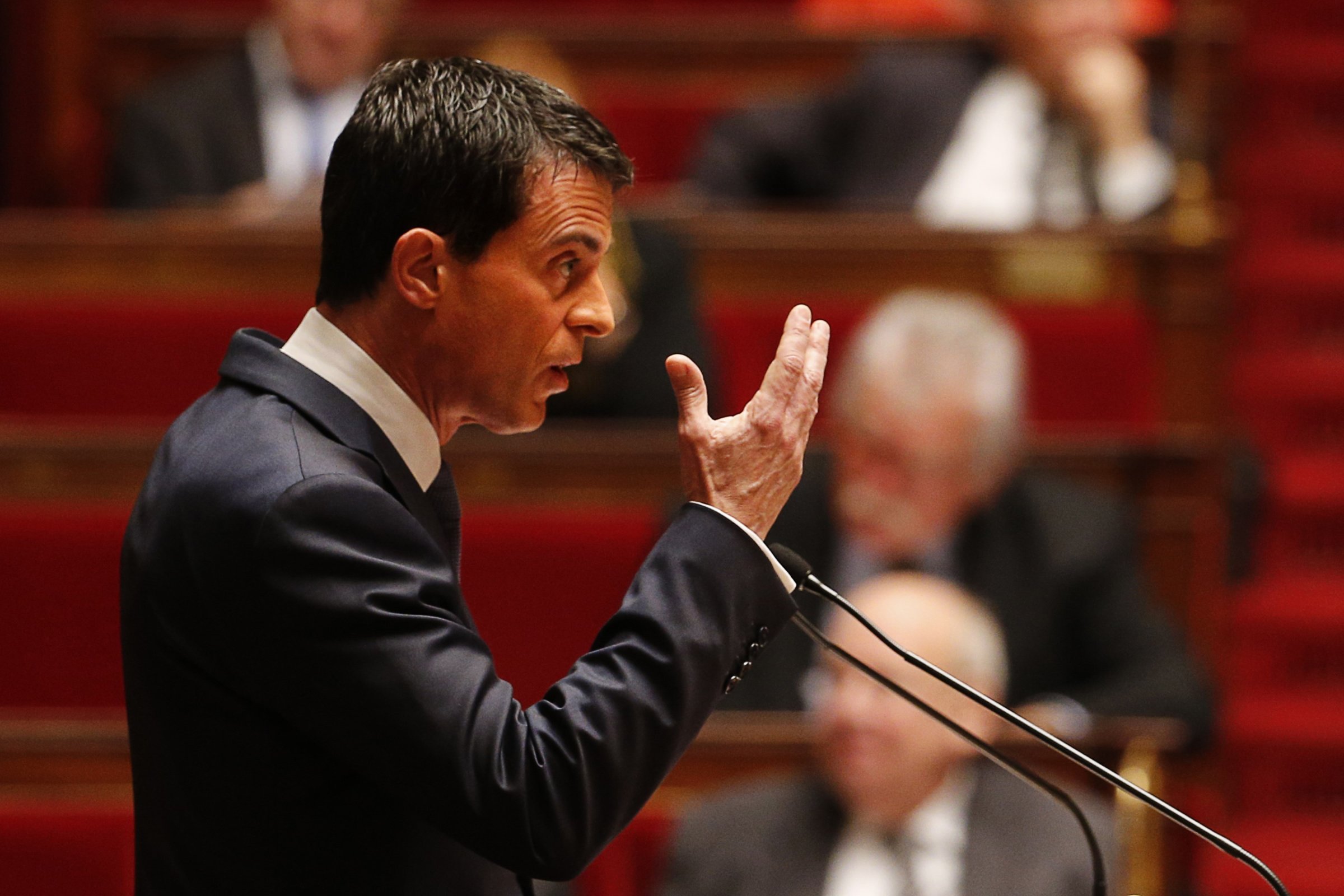 French Prime Minister Manuel Valls gestures as he addresses lawmakers debating a measure that would extend a state of emergency declared by the French president until the end of February, at the National Assembly in Paris on November 19, 2015.