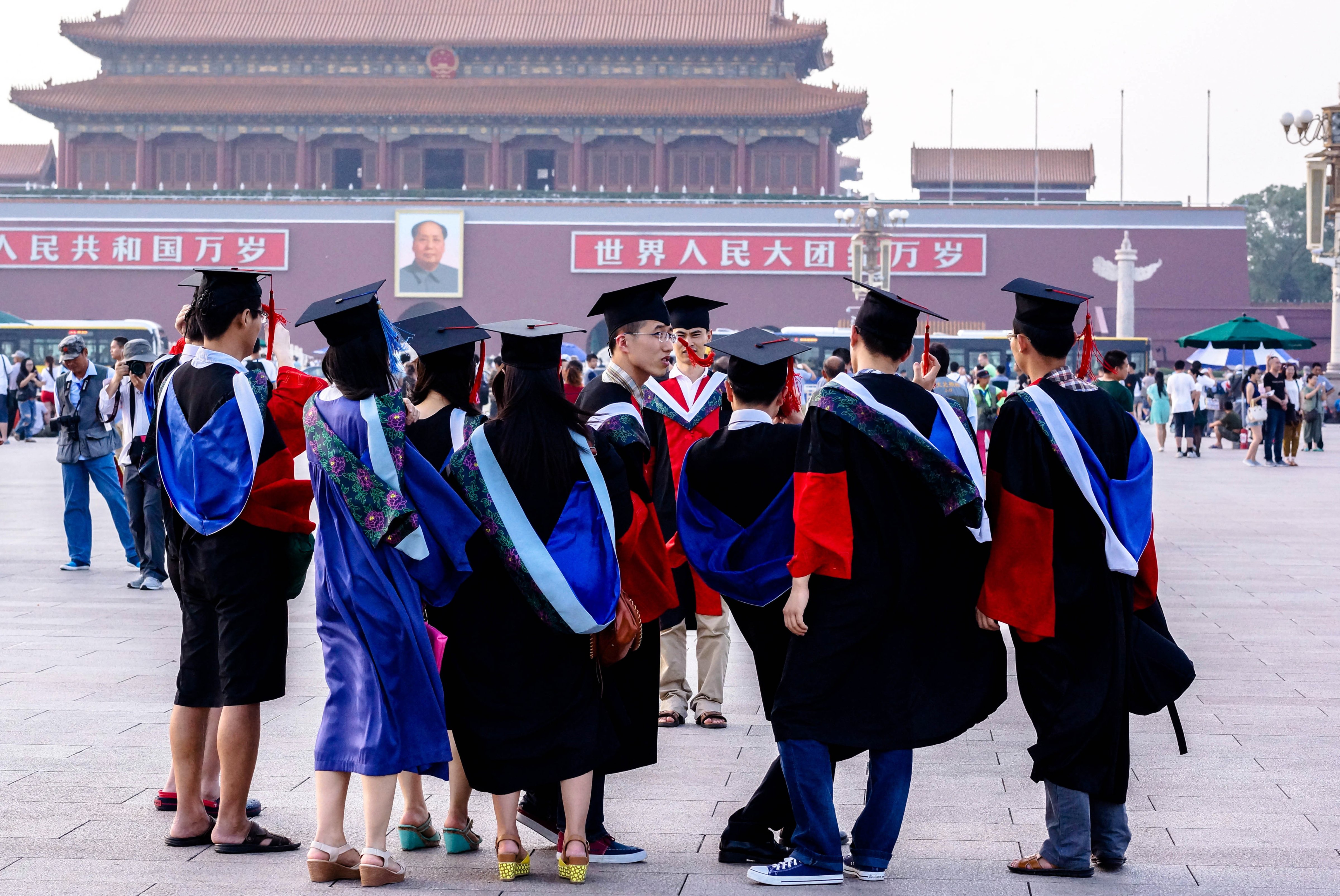 Graduates from Peking Union Medical College take commemorative photos in Tienanmen Square, Beijing, China, June 19, 2014 (Zhang Peng—LightRocket/Getty Images)