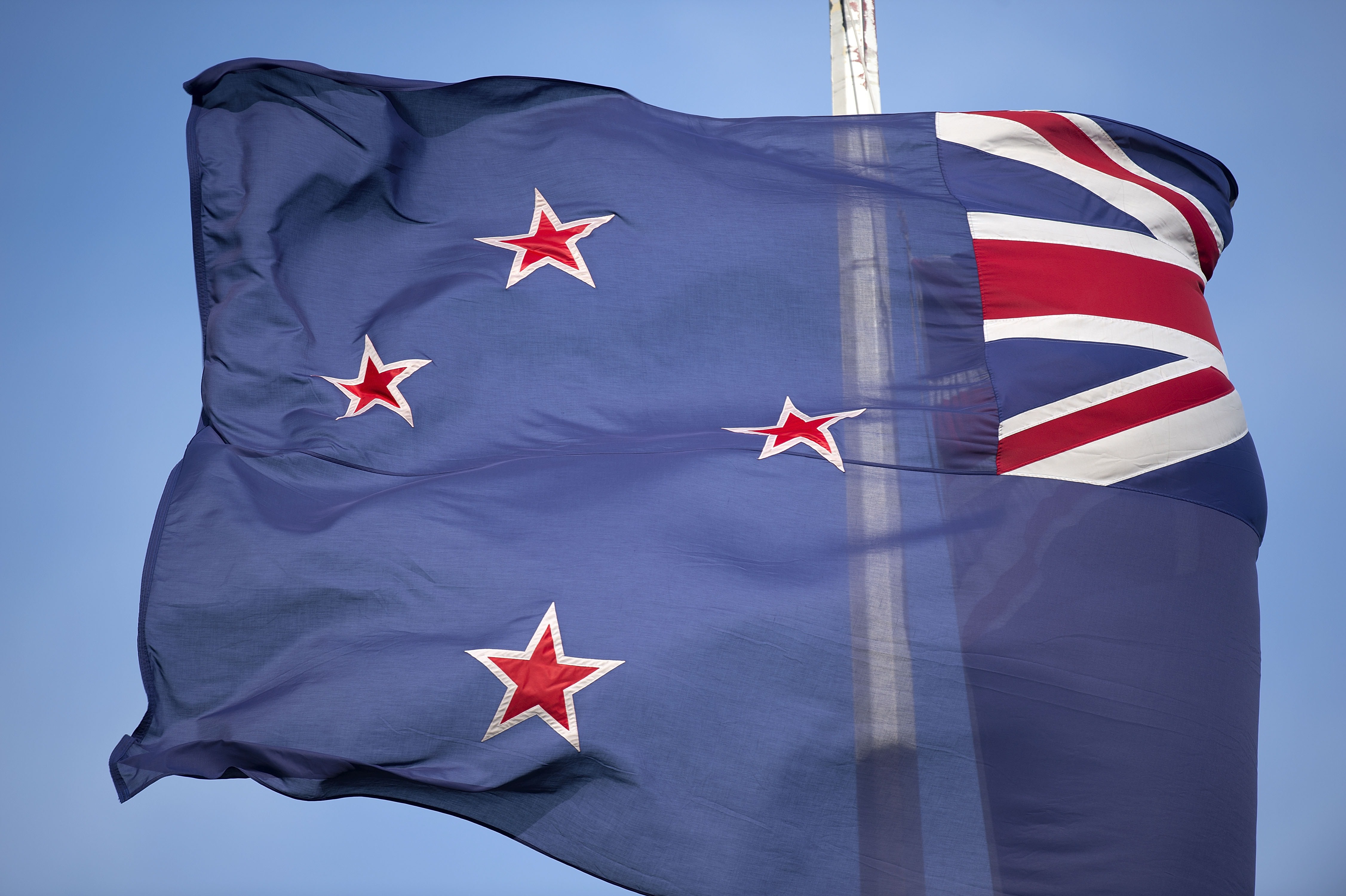 The current New Zealand flag flutters outside outside the New Zealand Post building in Wellington on Oct. 29, 2014 (Marty Melville—AFP/Getty Images)