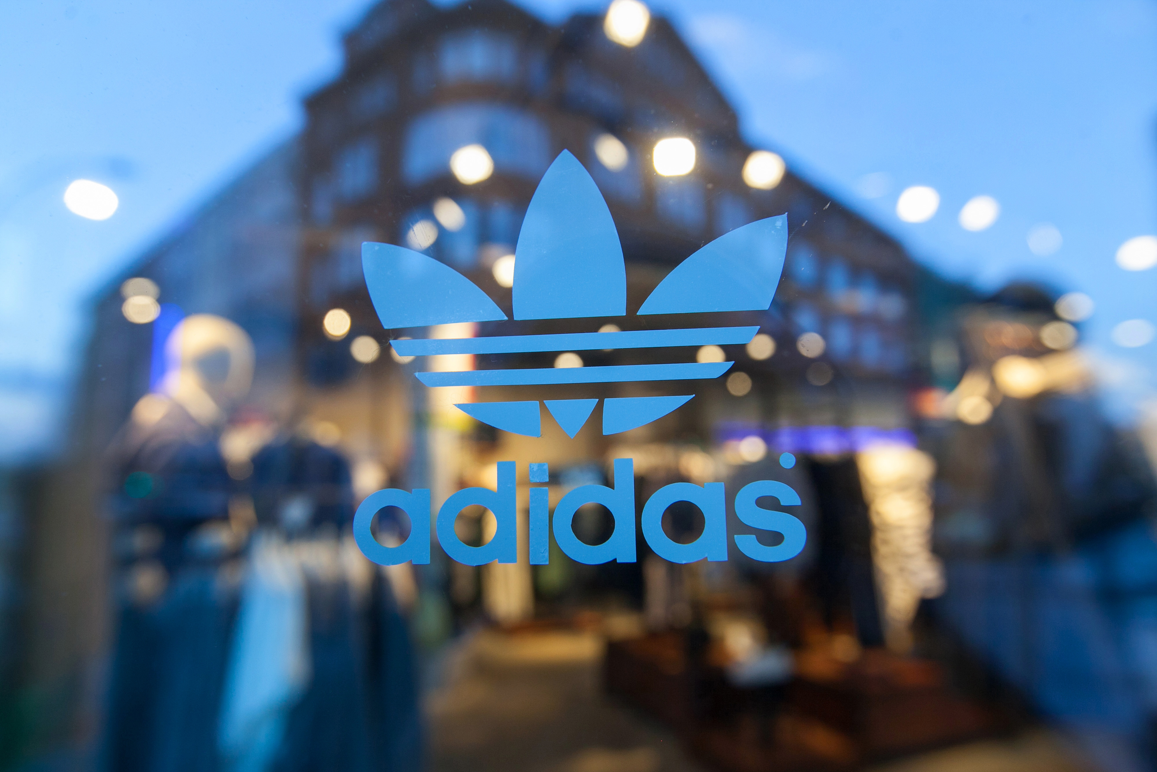 The Adidas logo sits on a window at an Adidas AG originals store in Berlin, Germany, on Wednesday, March 4, 2015. Adidas predicted profit growth for this year that matched analysts' predictions for the struggling German sportswear maker as it pours money into catching up to larger rival Nike Inc. in America. Photographer: Krisztian Bocsi/Bloomberg via Getty Images (Krisztian Bocsi—Bloomberg/Getty Images)